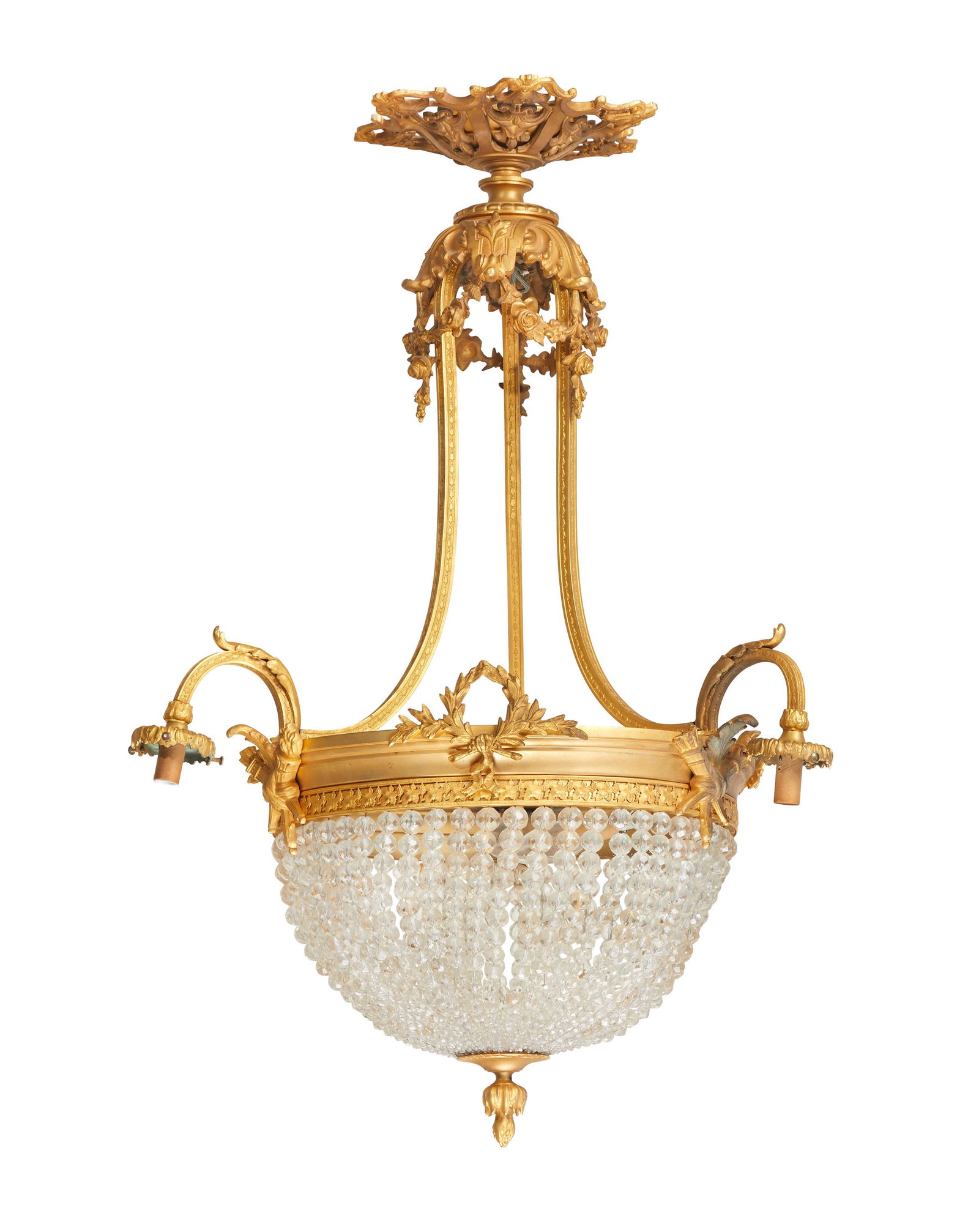 A French gilt-bronze chandelier: First-Quarter 20th Century The six-light, gilt-bronze chandelier with acanthus leaves and floral festoons issuing three out-swept arms, each terminating in a drop pendant light, surrounding a central 