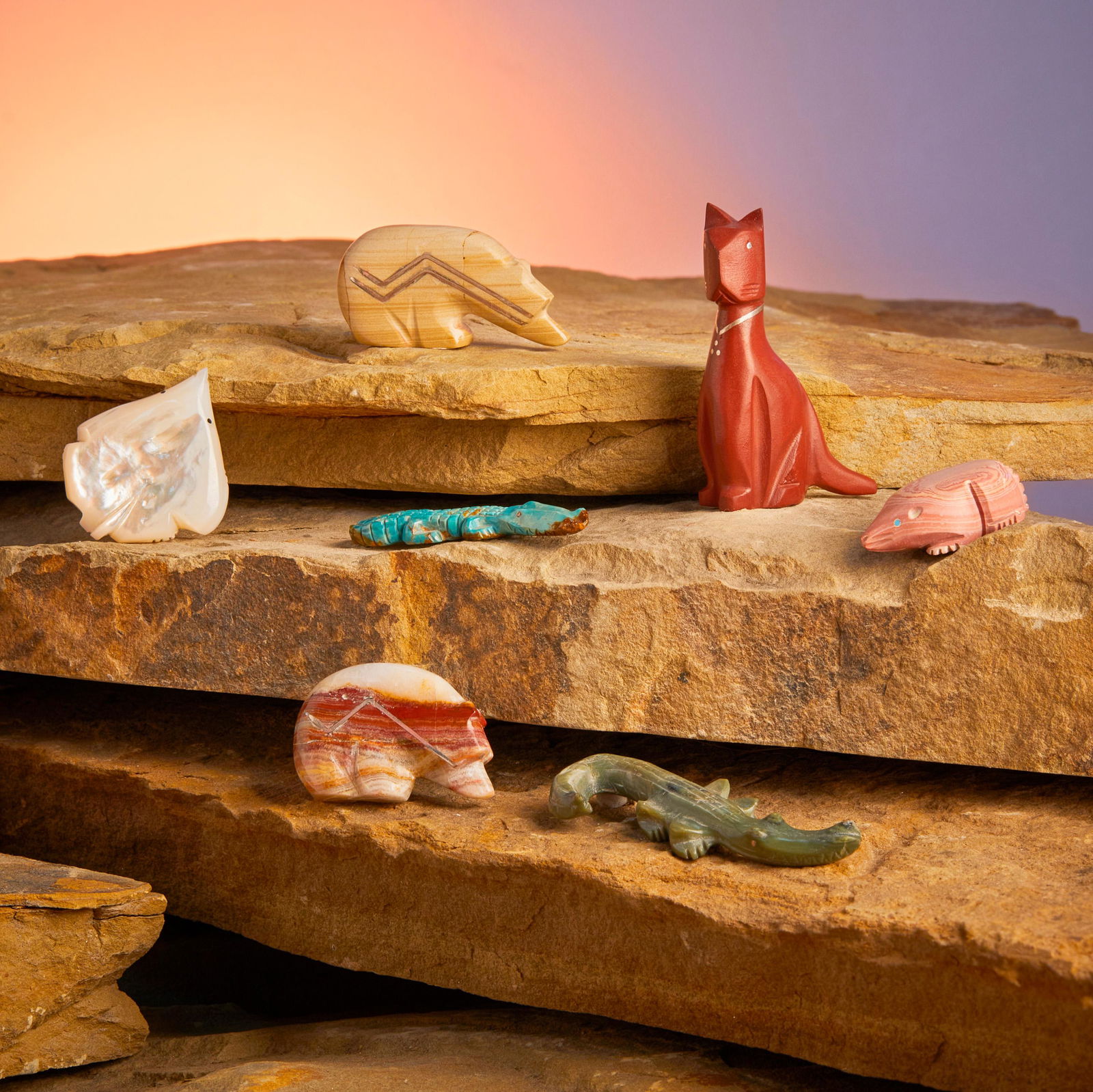 A group of Zuni stone fetish animals: Late 20th/21st Century Each variously marked Comprised of a pipestone cat, a serpentine crocodile, a turquoise alligator, a hickoryite bear, and a travertine onyx bear (Each Kenny Chavez), as well a