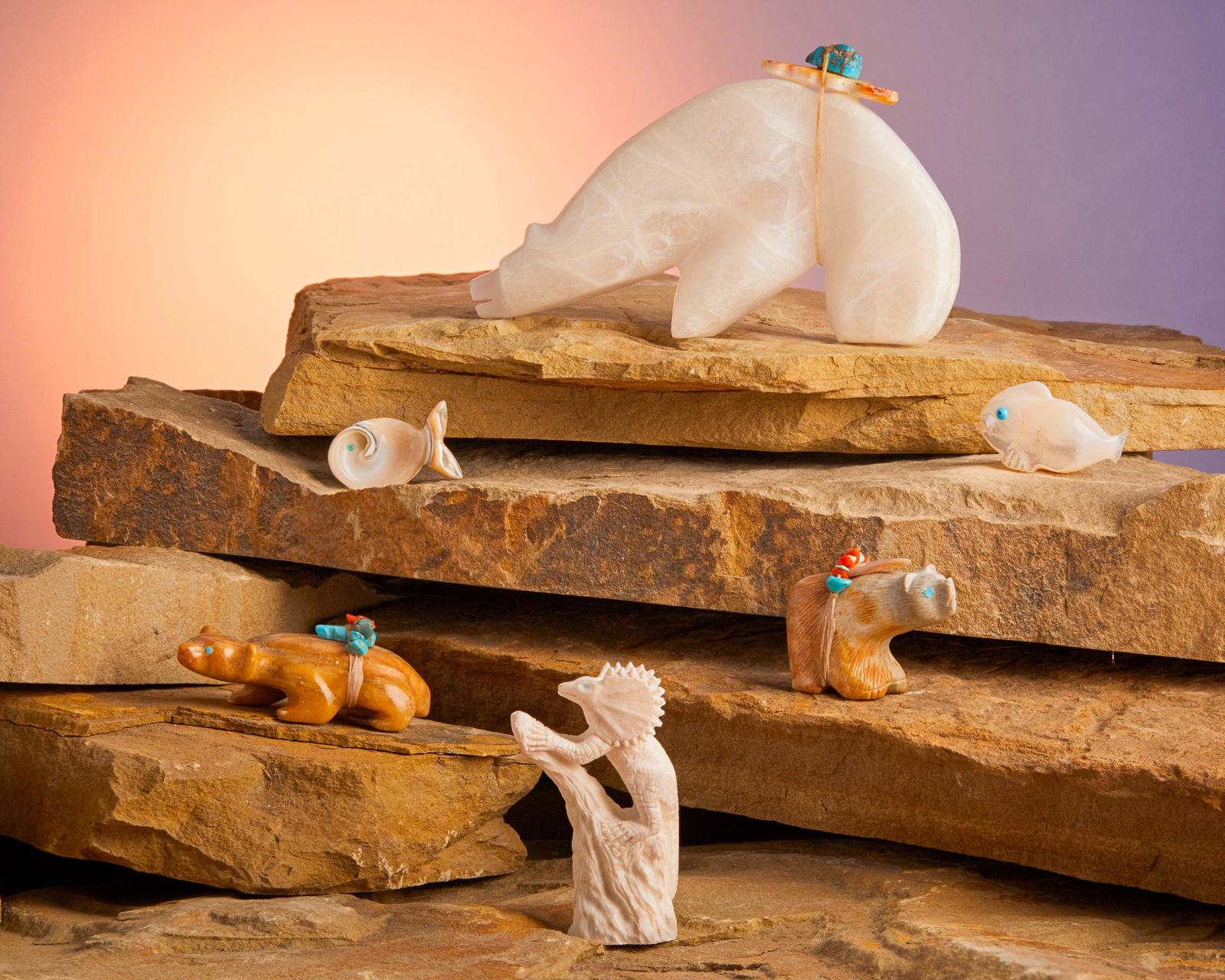A group of Zuni stone fetish animals: Late 20th/21st Century Four variously marked Comprising an alabaster medicine bear (Linde Paquin, Zuni), a butterscotch travertine badger (Travis Nieto, Zuni/Navajo), a Picasso marble bear (Randy Lu