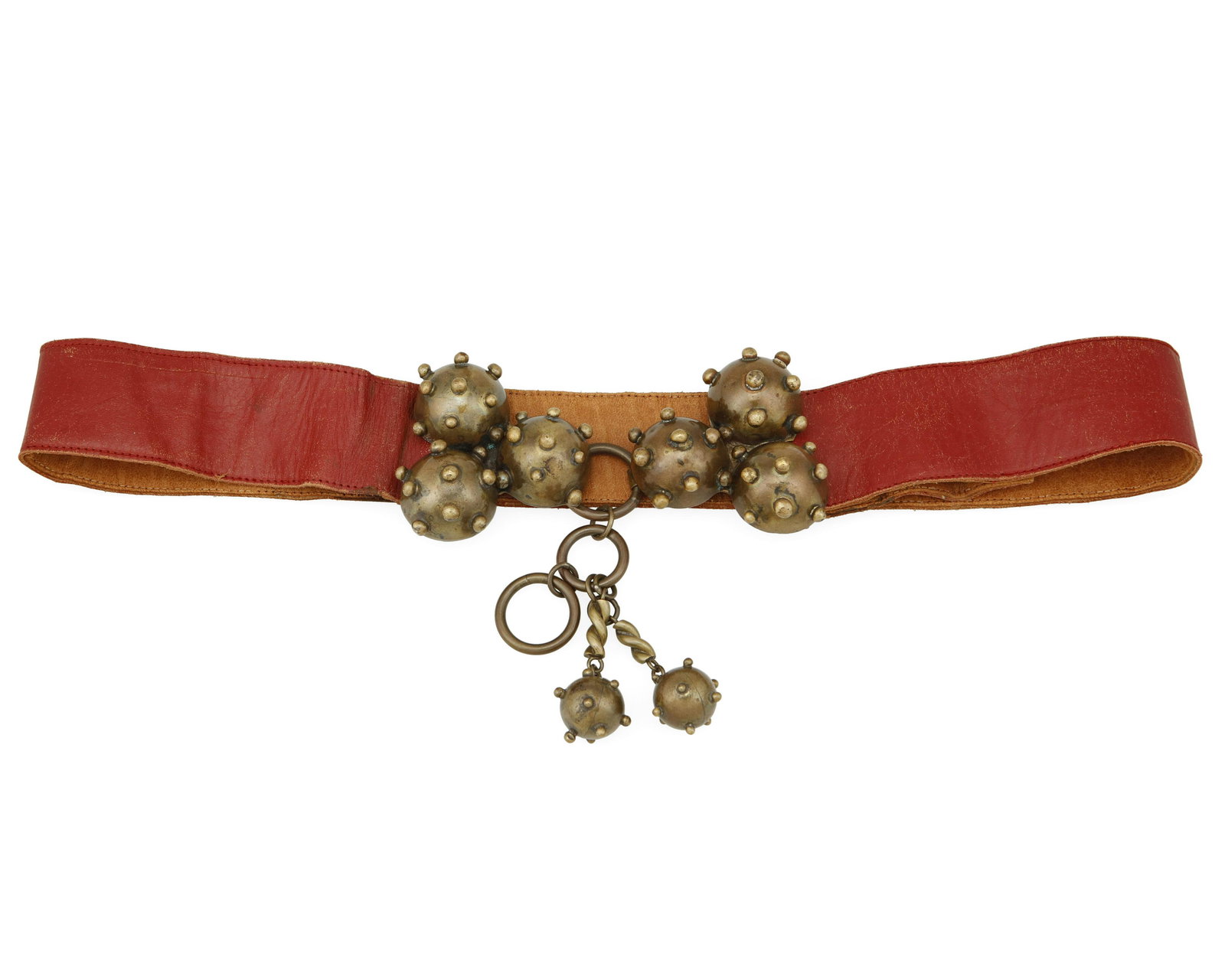 A Hubert Harmon brass belt buckle: Hubert Harmon (1913-2004) Circa 1942-1948; Taxco, Mexico Stamped: Hubert Harmon / Mexico Designed with whimsical stylized "Sputnik" brass bomb clusters in two parts, with the original attached red