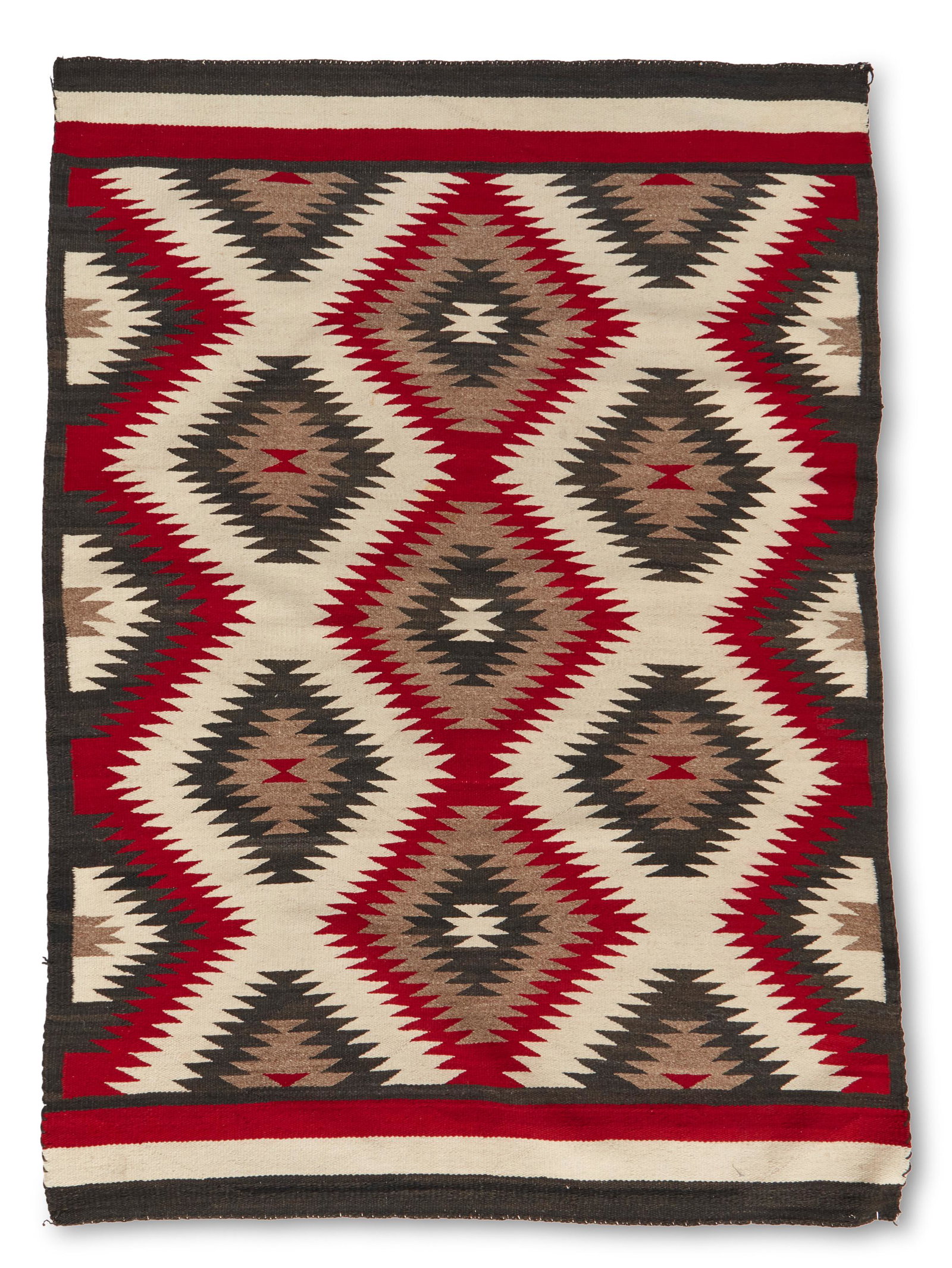 A Navajo regional rug: Mid-20th century; Dine Woven in red, cream, grey, and dark brown wool with serrated diamond motifs throughout and banding to two ends 55.75" H x 41.75" W Provenance: The Estate of George David Sturges