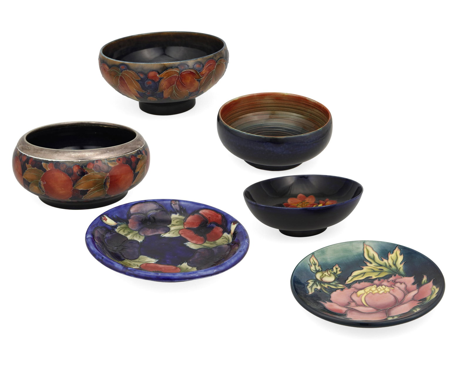A group of Moorcroft pottery: Late 20th/early 21st century; Burslem, England Each with Moorcroft backstamp; with further various dates and markings Each glazed ceramic with various floral and fruit motifs, comprising a bowl with s