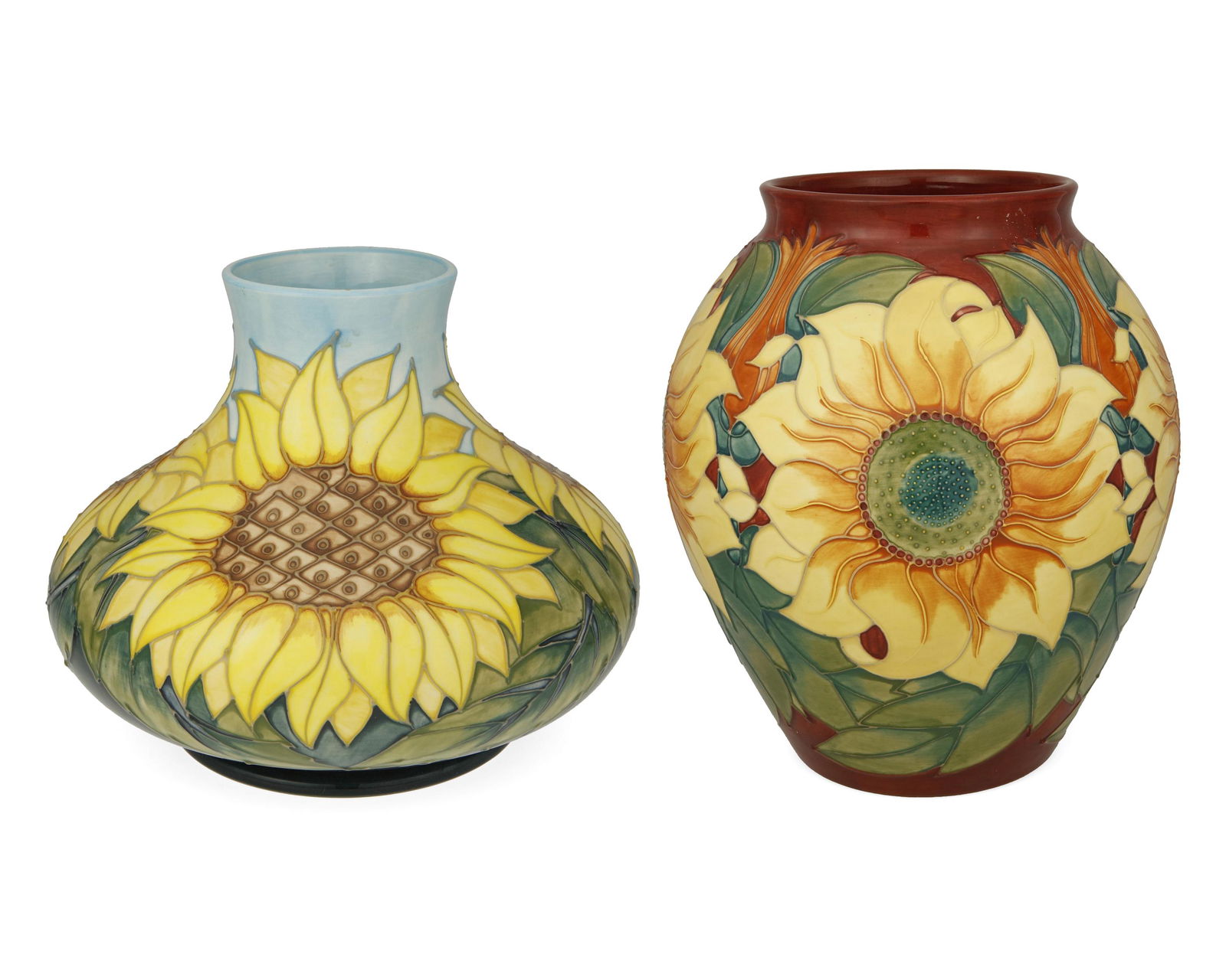 Two Moorcroft pottery sunflower vases: Circa 1990s; Burslem, England Each with Moorcroft backstamp; with further various dates and markings Each glazed ceramic vase with sunflower motifs, 2 pieces Largest: 10.5" H x 8.5" Dia.