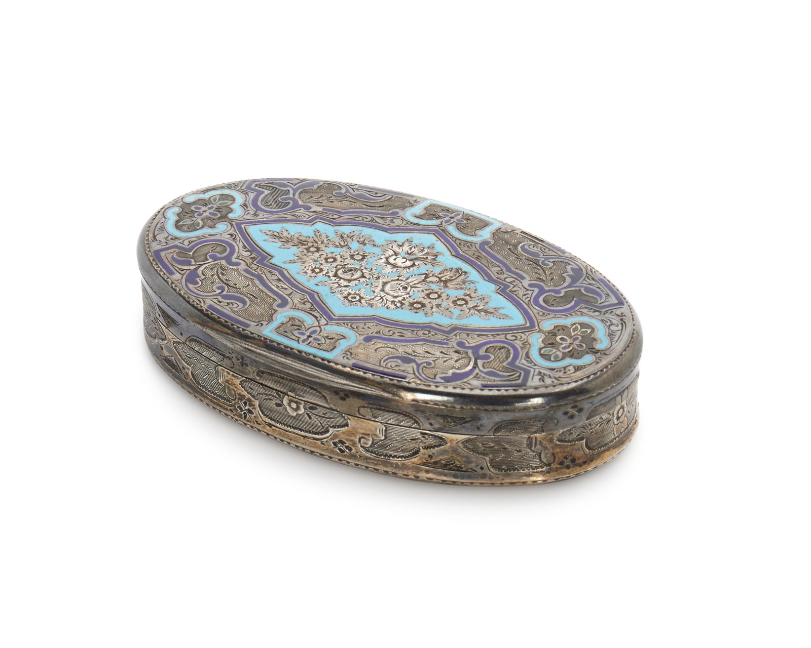 A French silver and champleve snuff box: Late 19th/early 20th century Marked with Minerva head for .950 silver The oval box with chased floral designs and blue champleve enamel to the lid 0.625" H x 3.25" W x 2.125" D 2.27 gross oz. troy