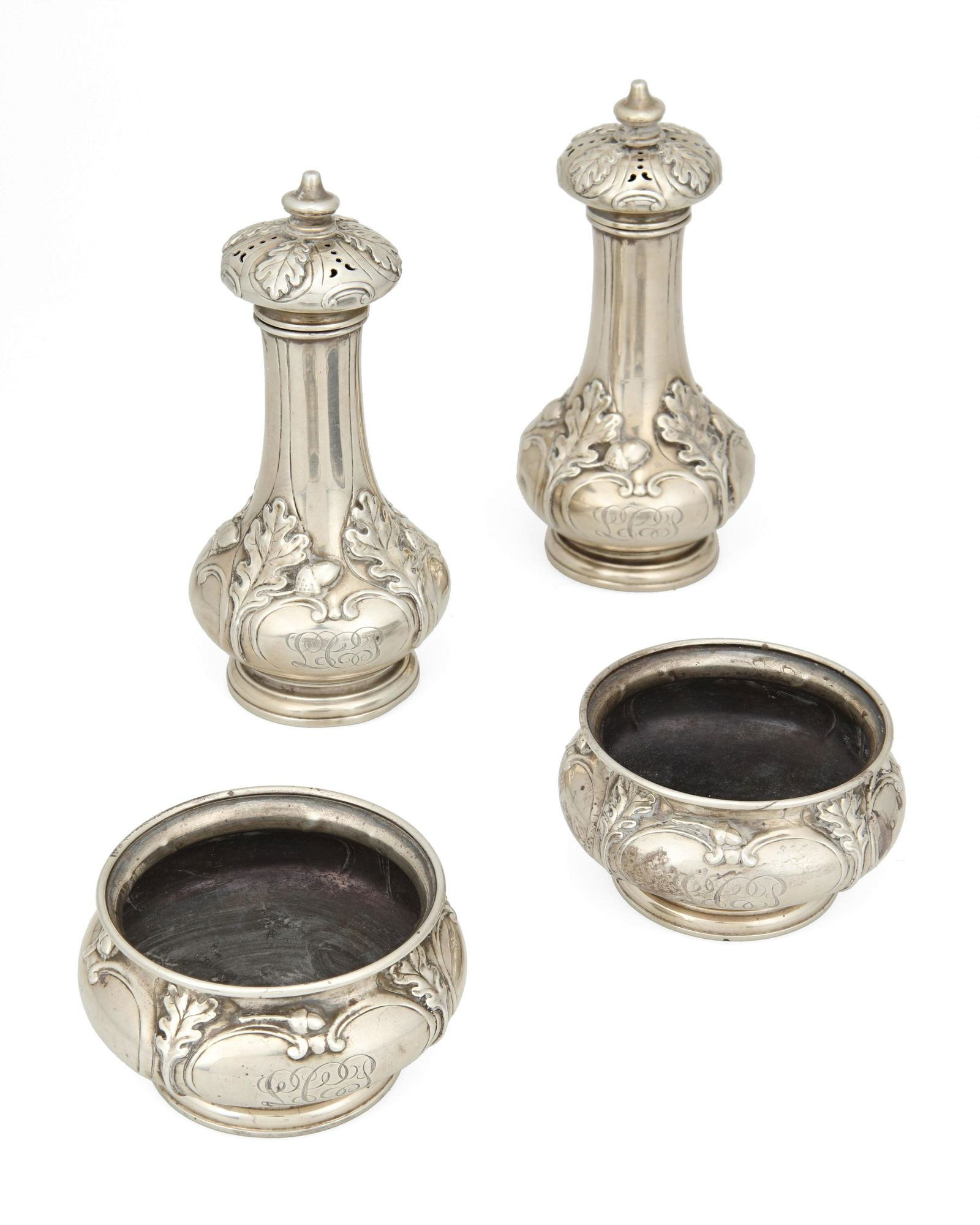 A group of Gorham sterling silver table items: 20th century Each marked for Gorham sterling Each with oak leaves and acorns, comprising a pair of sugar casters (5.25" H x 2.5" Dia.) and a pair of master salt cellars (1.625" H x 3" Dia.), 4 piece