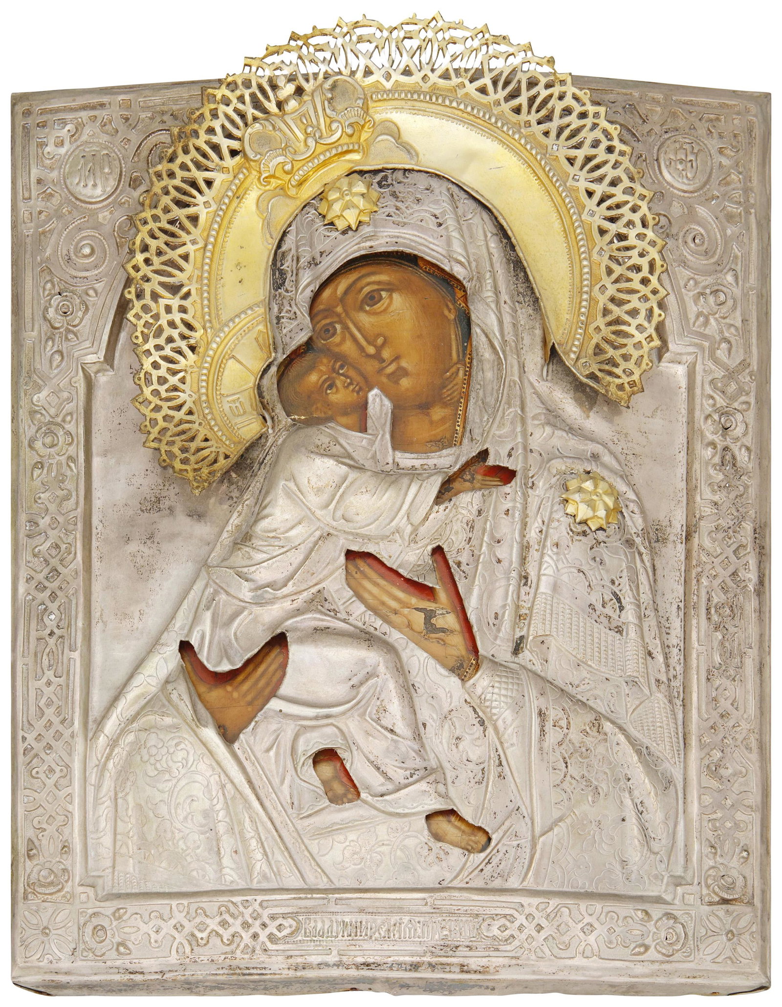 A Russian silver and gold wash icon: Signed in Russian to the verso; appears otherwise unmarked Painted wood depicting the Madonna and child with a silver oklad and gilt coronation and stars 13.75" H x 11" W x 1.25" D Provenance: The Est