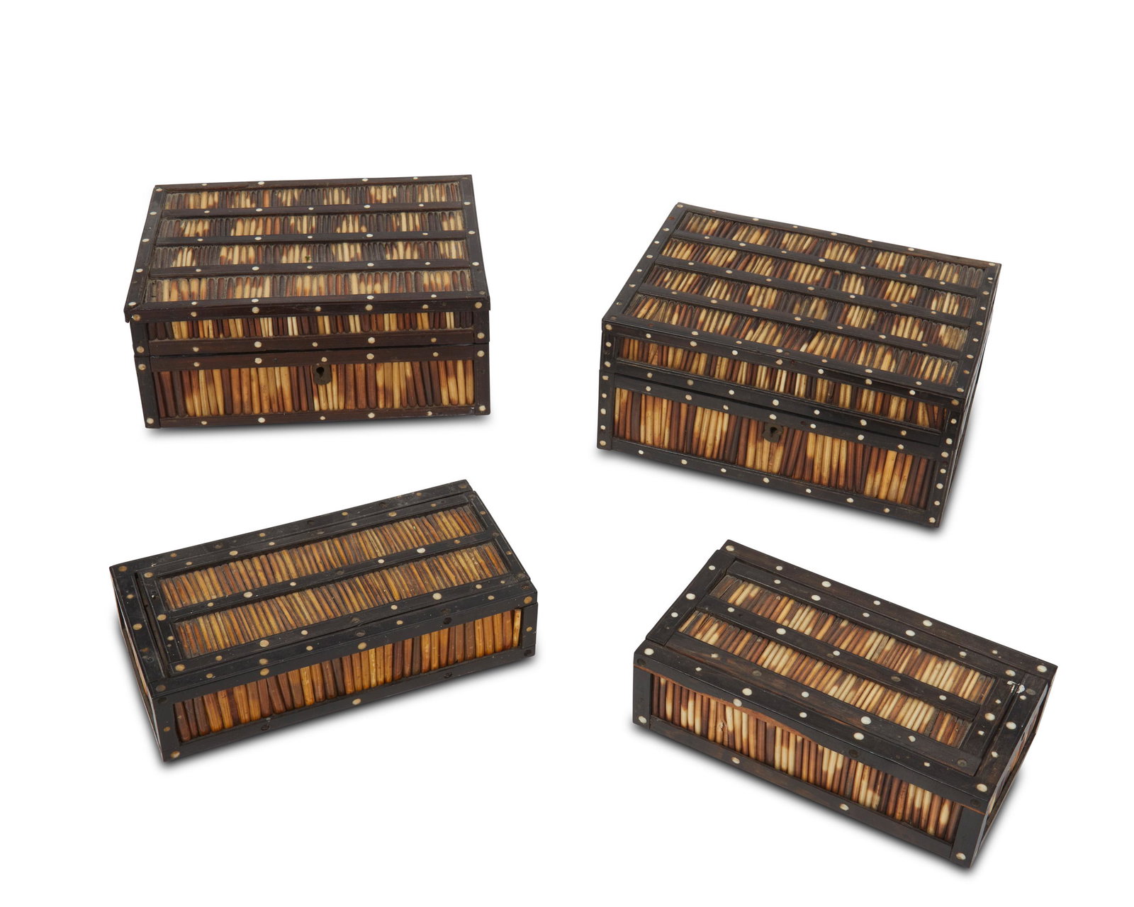 Four Sinhalese porcupine quill and ebony boxes: Late 19th/early 20th century A group of Sri Lankan-made boxes constructed out of porcupine quills and ebony wood with ivory disc inlay; the two smaller boxes have a sliding mechanism lid while the two