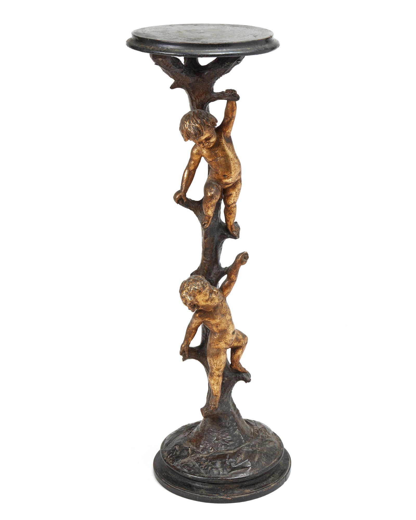 An Italian carved giltwood stand: Late 19th/early 20th century In the form of two gilt putti balancing on a trunk 42" H x 13" Dia.