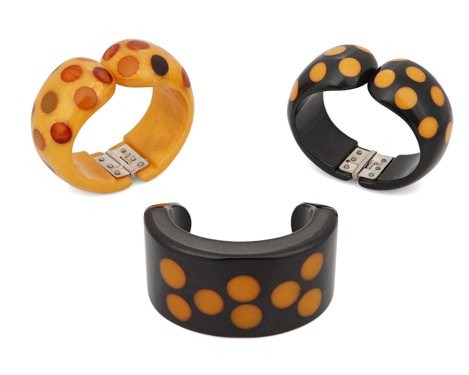 Three Bakelite dot cuff bracelets: Three Bakelite dot cuff braceletsLate 20th/21st centuryComprising three bracelets including two hinged "Multi Dot" design bracelets by Jorge Caicedo Montes de Oca, one dark and one yellow, e