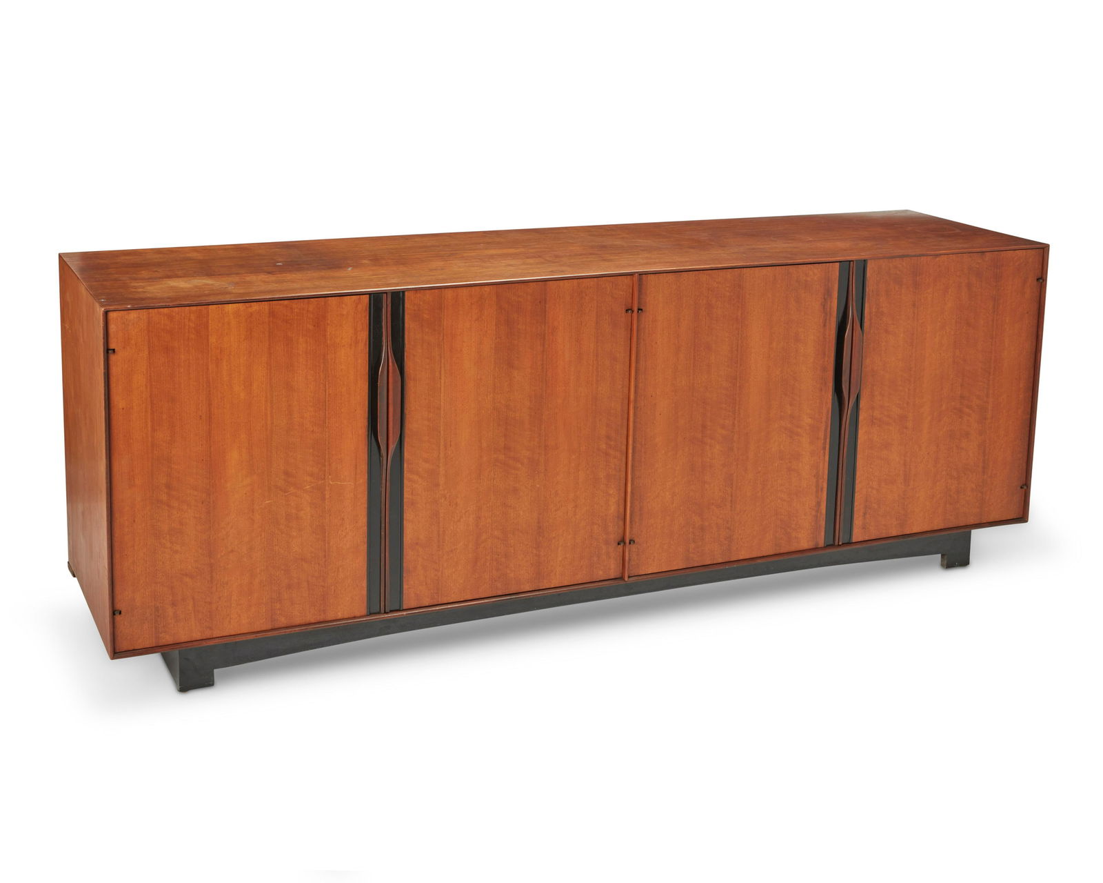 A John Kapel for Glenn of California modern walnut credenza Circa 1960s 30.25" H x 80" W x 20" D: A John Kapel for Glenn of California modern walnut credenzaCirca 1960sWith Glenn of California metal tag to drawerThe low-profile walnut buffet with two cabinets with sculpted handles revealing a fitt