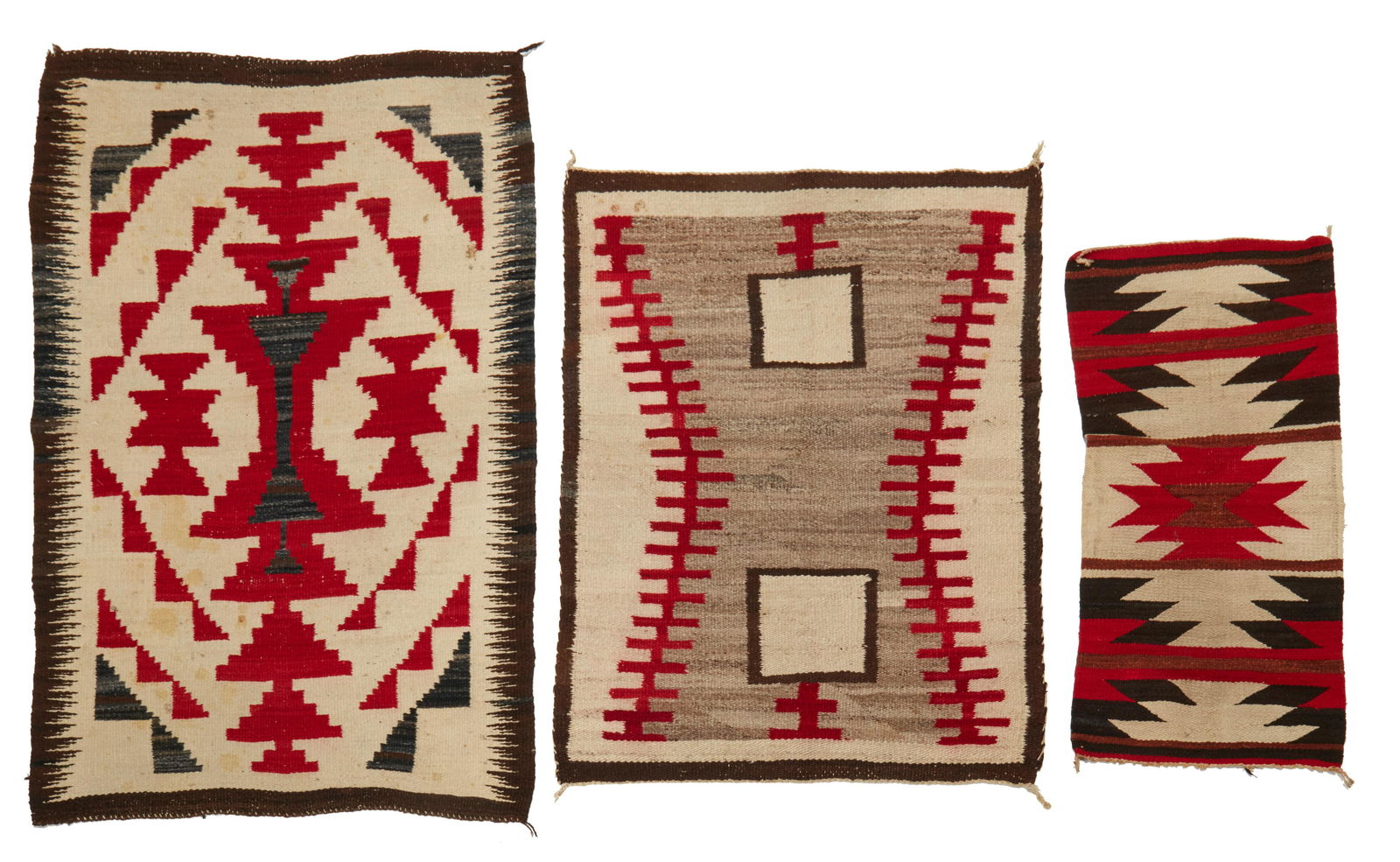 A group of Navajo rugs: A group of Navajo rugsMid-20th century; DineComprising three rugs including a small table runner in red, cream, brown and black wool with central serrated diamond (36" H x 17.5" W), a double