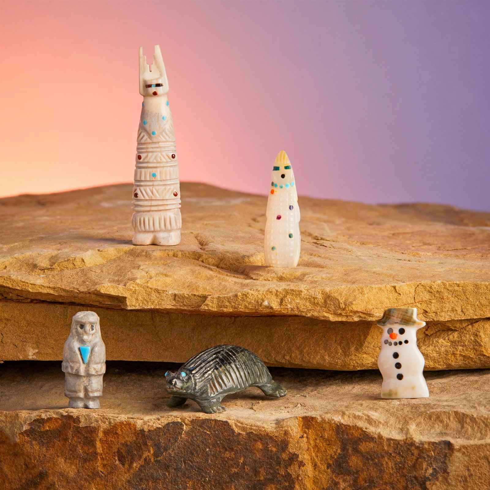 A group of Zuni stone fetish figures: A group of Zuni stone fetish figures Late 20th/21st century Each variously marked Comprising a nephrite turtle (Karen Zunie), a carved bone man (Marlo Booqua), a mother-of-pearl corn maiden (DN), a bo