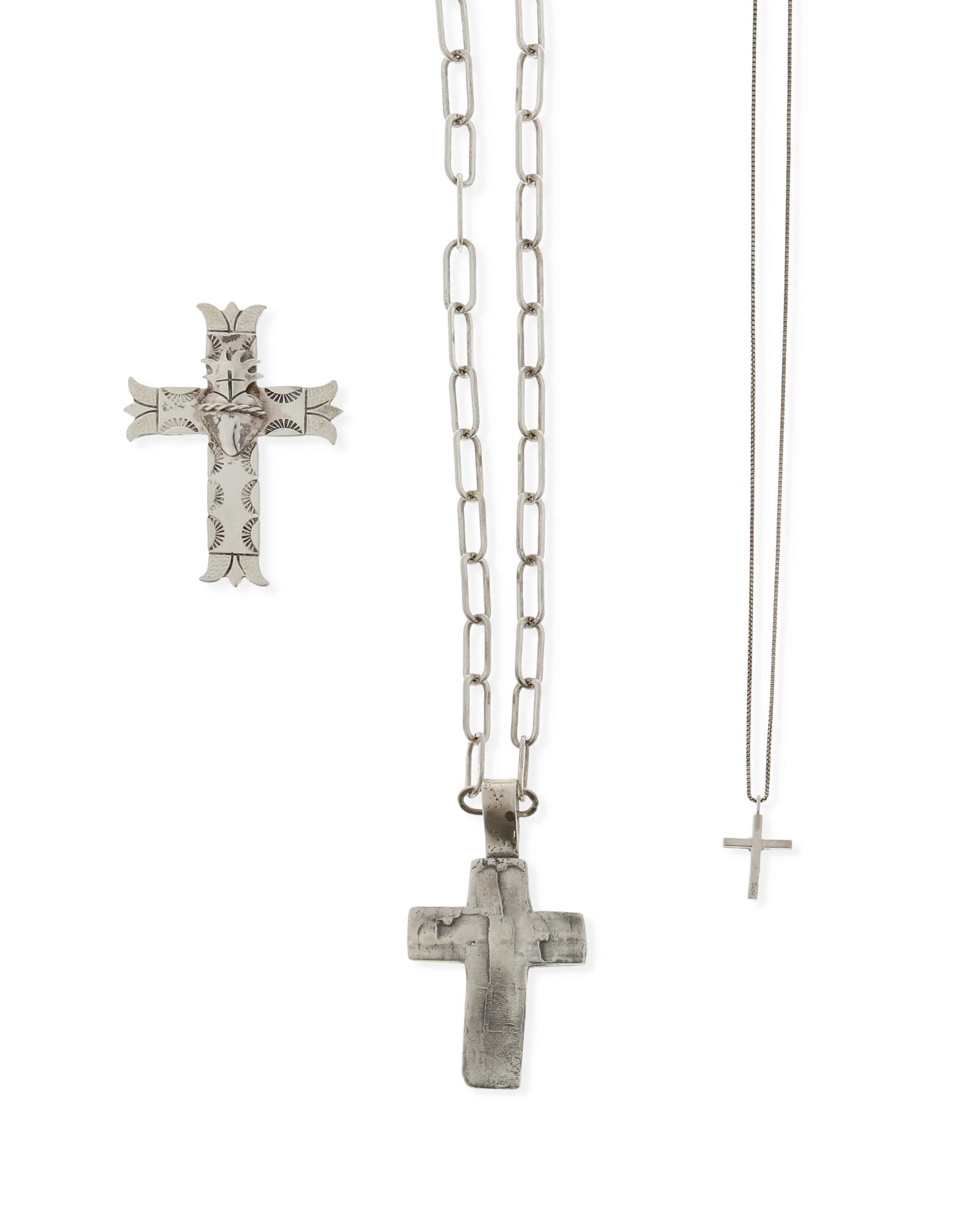 A group of silver jewelry: A group of silver jewelry Late 20th/early 21st century; New Mexico Comprising a Juan Lopez stamped and overlay sacred heart cross pendant (stamped: JL [conjoined]; 2.375" H), a Lawrence Baca cast