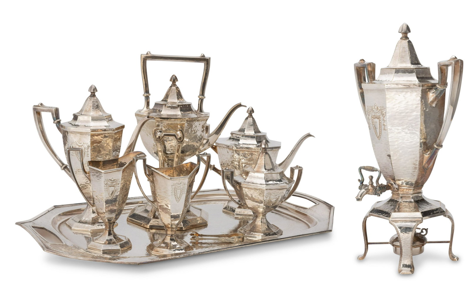 A Meriden Brittania silver-plated tea and coffee service: A Meriden Britannia silver-plated tea and coffee service Early 20th century Each marked for Meriden Britannia Each hand-hammered silver-plate decorated with a shield surmounted by an urn and bellflowe