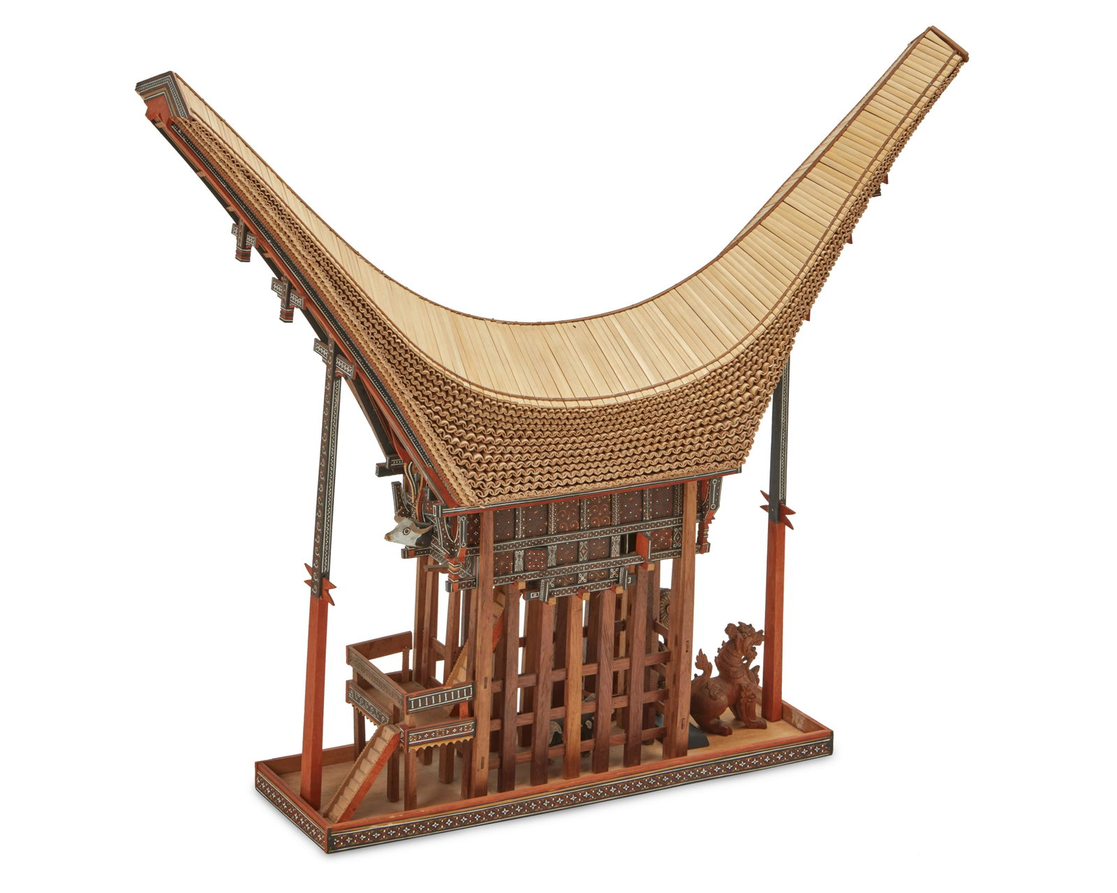 A polychromed wood and bamboo model of a Torajan spirit house: A polychromed wood and bamboo model of a Torajan spirit house 20th century; Torajan Peoples, Sulawesi, Indonesia Appears unmarked The model traditional house of the Torajan Peoples with a dramatic, sa