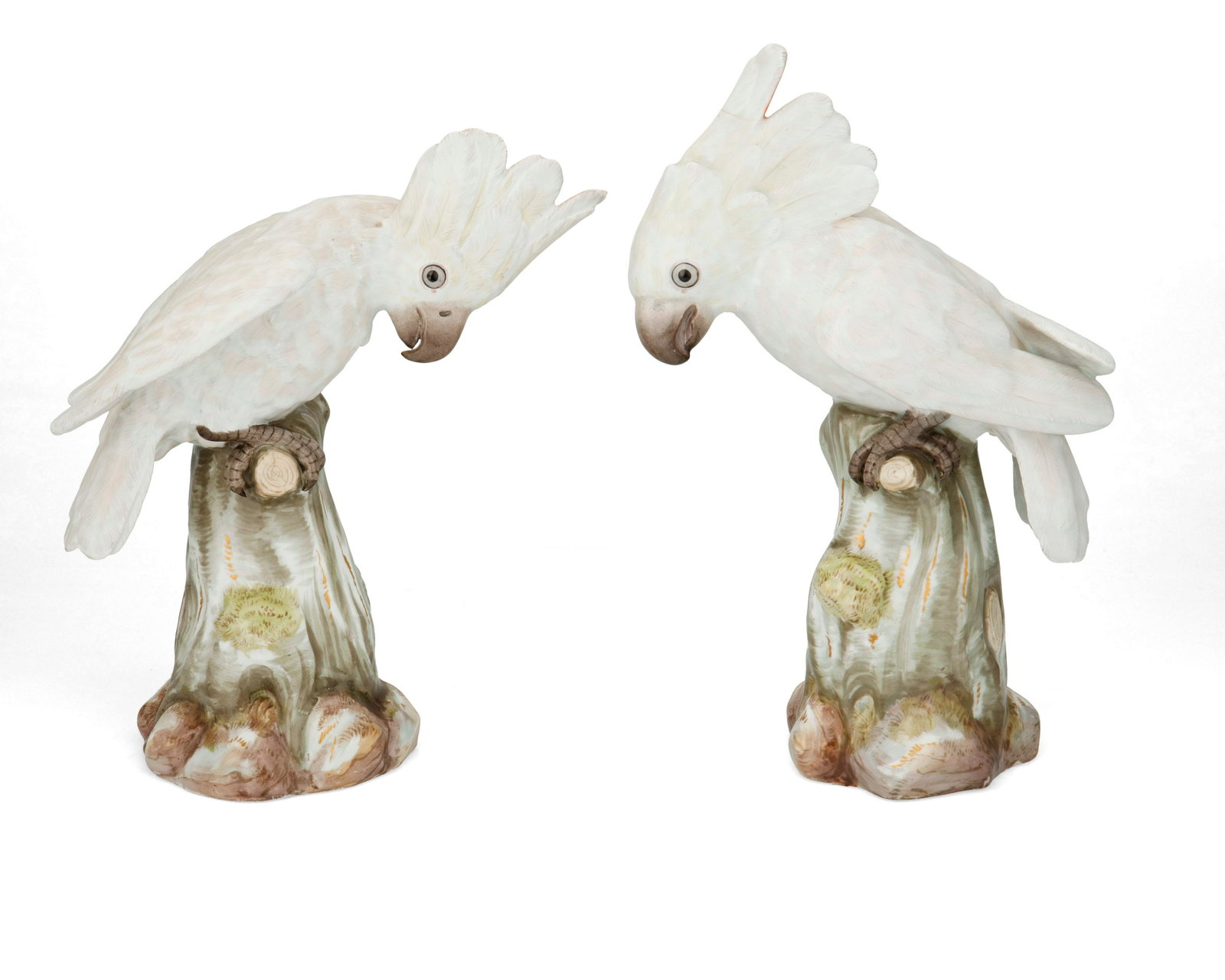 A pair of Meissen porcelain cockatoo figures: A pair of Meissen porcelain cockatoo figures Late 19th/early 20th century Marked for Meissen [blue crossed swords]; further marked with impressed numbers Each glazed porcelain cockatoo with white and 