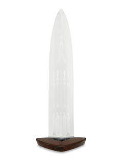 A Steuben crystal "Cathedral" obelisk sculpture: A Steuben crystal "Cathedral" obelisk sculptureMid-20th centuryWith engraved signature: SteubenDesigned circa 1954 by George Louis Thompson (1913-1981), the clear lead glass triangular obelisk in the