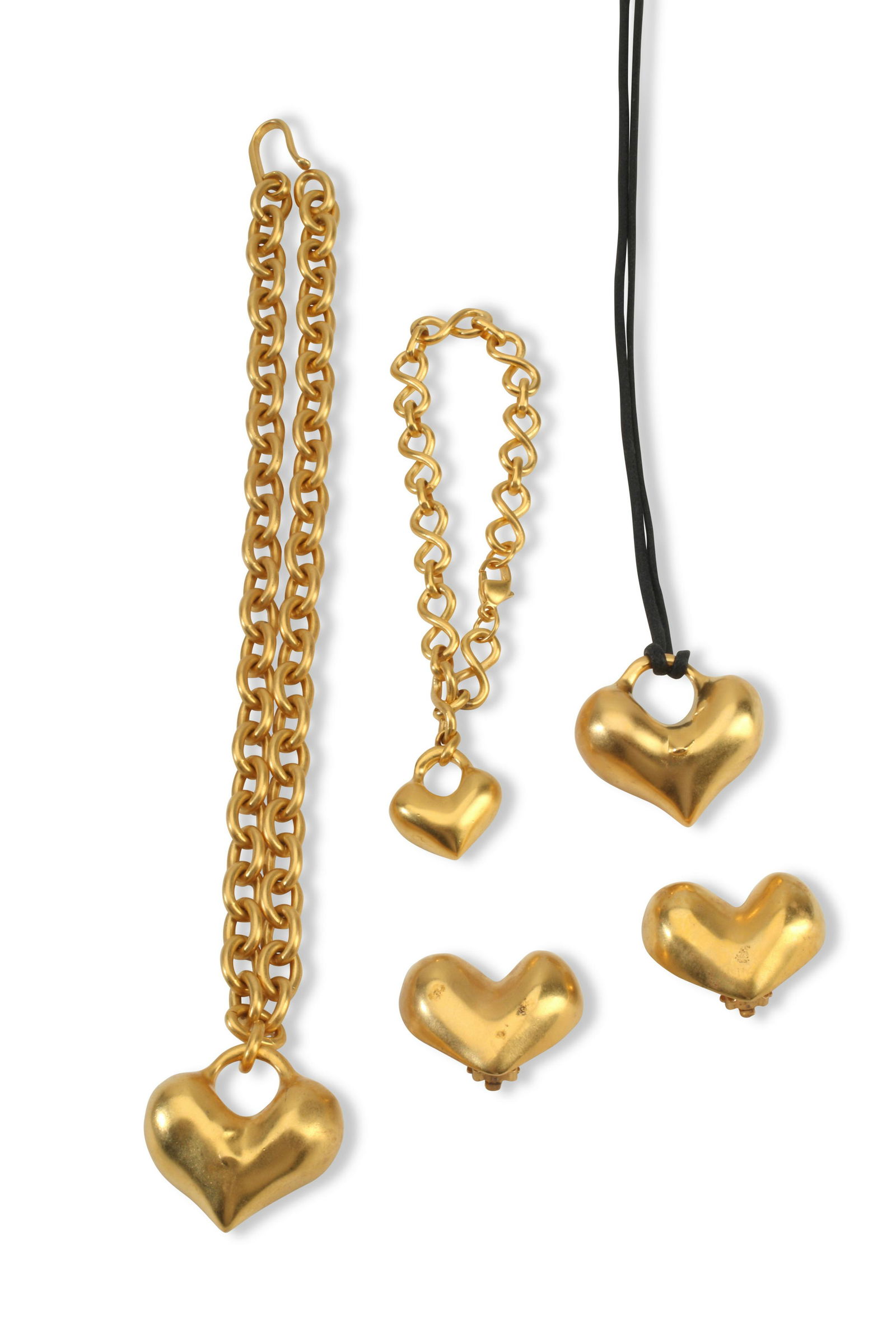 A set of vintage Robert Lee Morris matte gold heart jewelry: A set of vintage Robert Lee Morris matte gold heart jewelryMarked for Robert Lee MorrisA group comprising a 24k matte gold-plated heart pendant on chain (16" L), a matching heart pendant on a bla