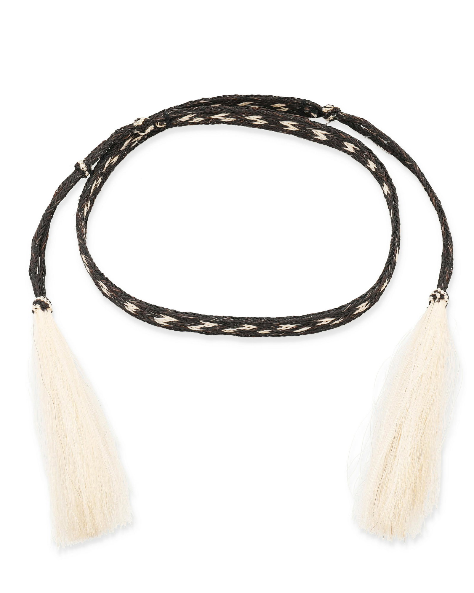 A braided horsehair belt/hatband: A braided horsehair belt/hatband 20th century Braided in dark brown and blonde horse hair, terminating in tassels 63" L x 0.75" W Provenance: The Estate of Oscar and Barbara Leidenfrost Othe