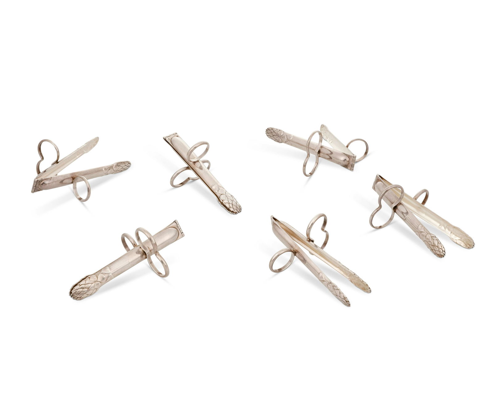 A set of Christofle asparagus tongs: A set of Christofle asparagus tongsCirca 1930sEach marked: [scales, for silverplate] / ChristofleThe pairs of hinged tongs in the shape of asparagus, with finger rings, 6 piecesEach: 4.75"