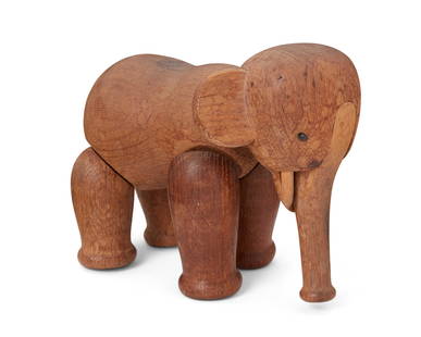 A Kay Bojesen-style elephant toy: A Kay Bojesen-style elephant toy Mid/late 20th century With burned mark: Denmark The carved wood elephant with articulating legs, head, and trunk in the manner of Kay Bojesen's 1953 design 5" H