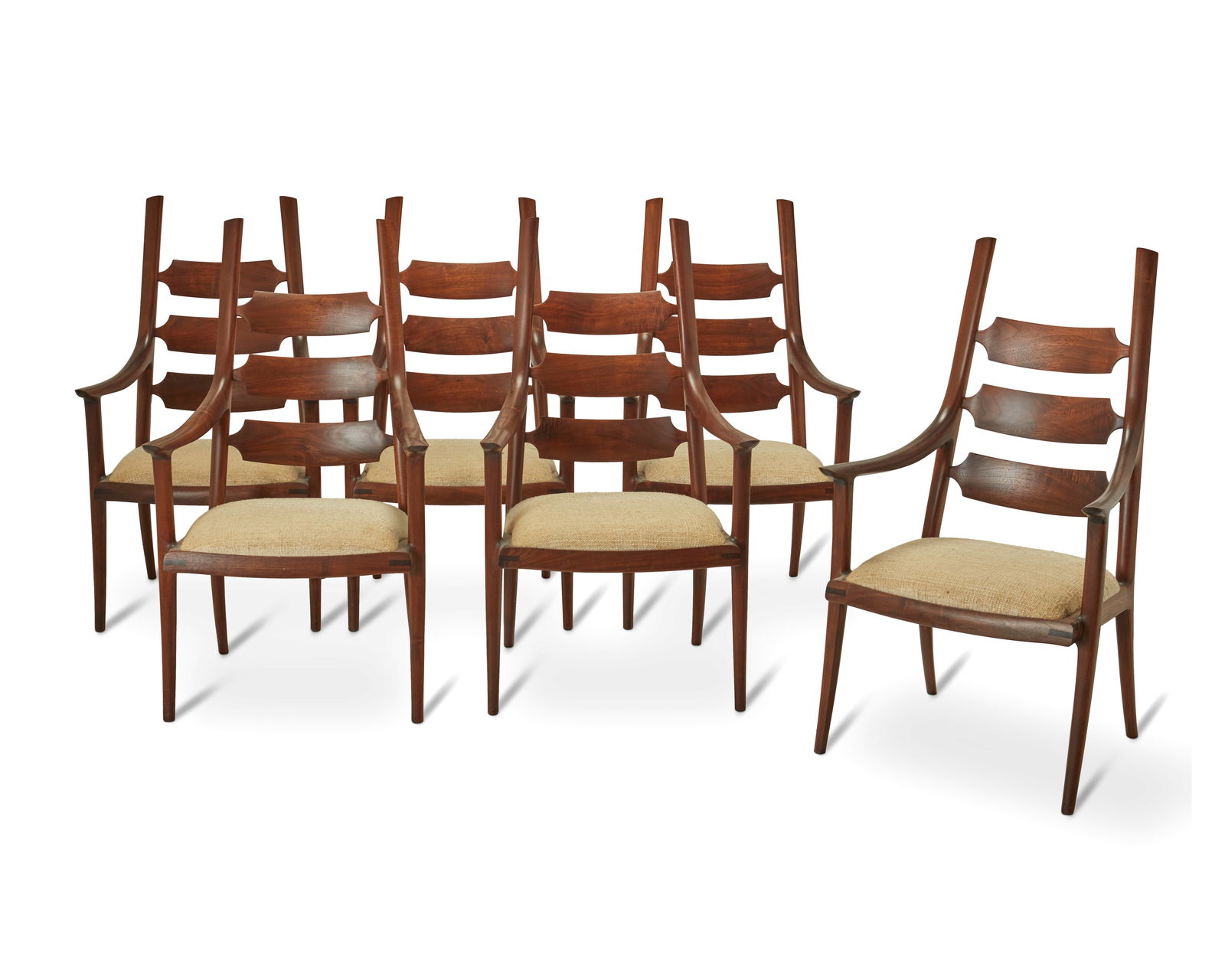 John Nyquist (1936-2018), Six walnut ladder-back dining chairs, circa 1990s, Each: 41.25" H x 22" W: John Nyquist (1936-2018)Six walnut ladder-back dining chairs, circa 1990sDesigned circa 1990sEach marked with the Nyquist logo incised to the undersideEach chair with walnut curvilinear frame, three b