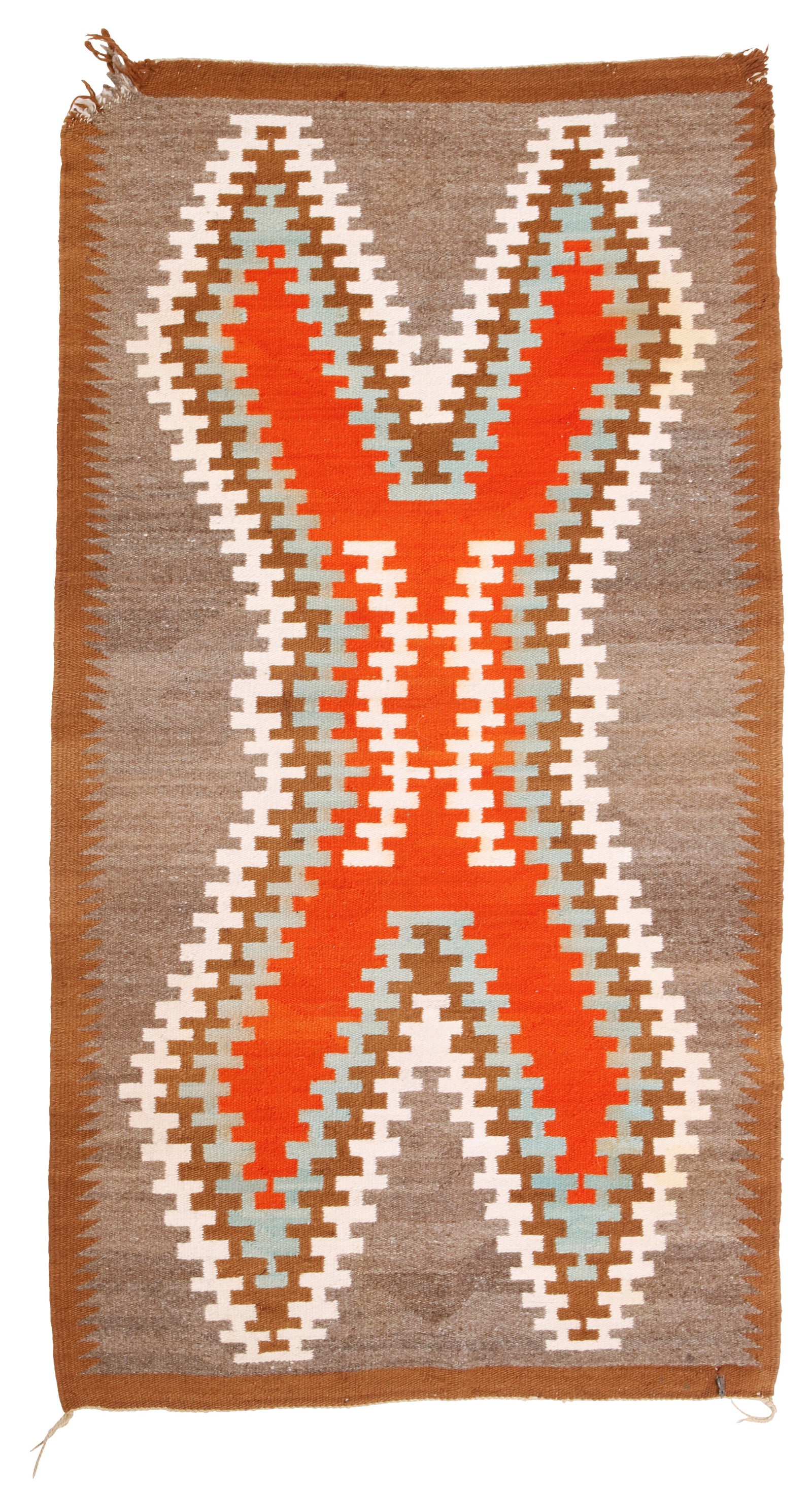 A Navajo regional rug: A Navajo regional rug Mid-20th century; DinE Woven in brown, grey, orange, blue and cream wool with a large hatched concentric X-motif to center and serrated borders 58" H x 32" W