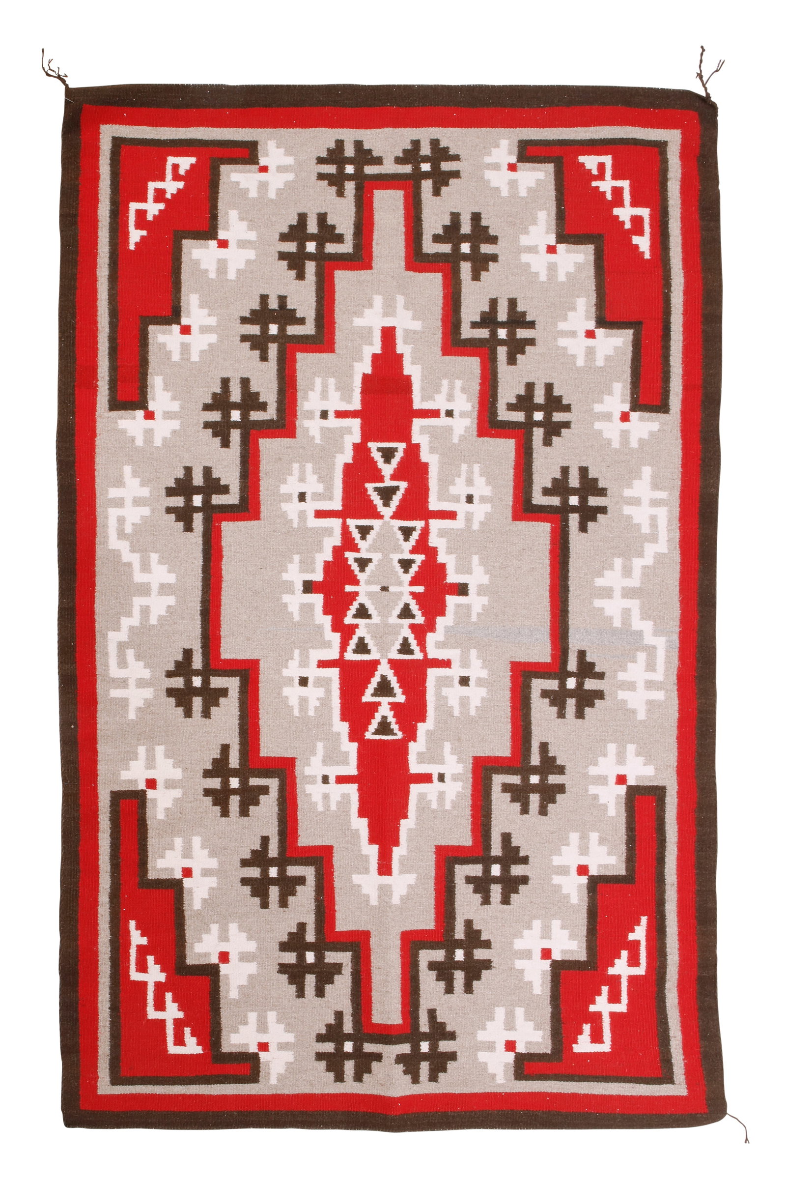 A Navajo Ganado regional rug: A Navajo Ganado regional rug Mid/late 20th century, DinE Woven in red, grey, brown, and cream wool with an elaborate central stepped diamond 66" H x 42" W Provenance: Private Collection, Sou