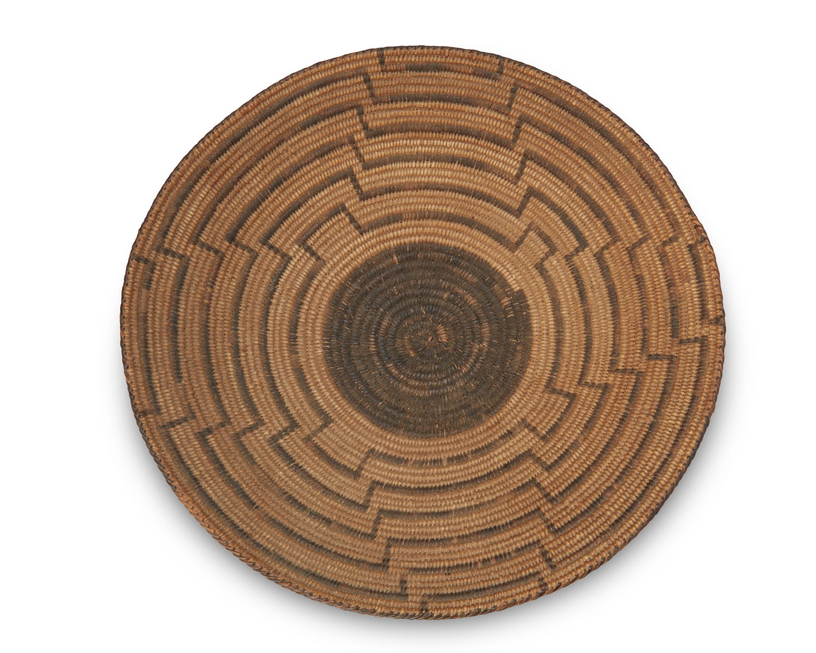 A Pima basket: A Pima basket Early/mid-20th century; Akimel O'odham, Southwest United States A large coiled basketry bowl with central black center and concentric radiating bands 4" H x 15.5" Dia.