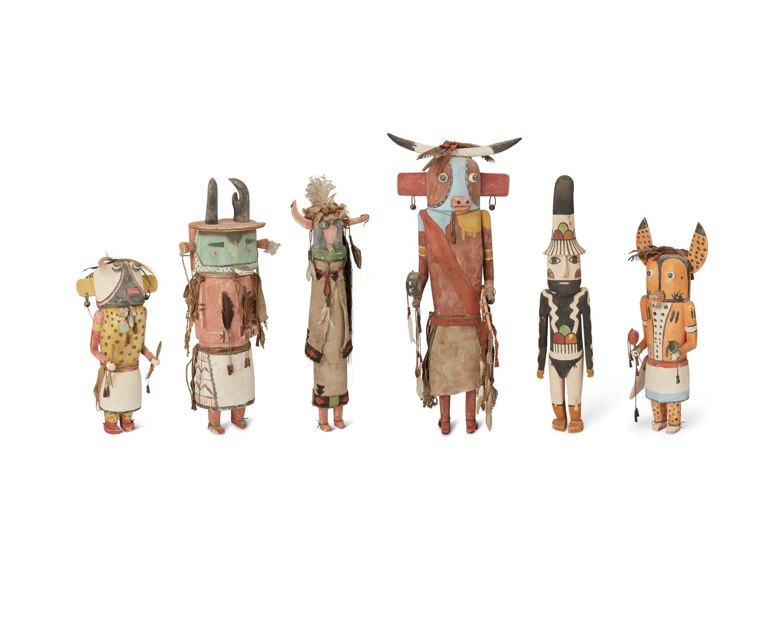 A group of Puebloan katsina figures: A group of Puebloan katsina figures Late 20th century, Southwest United States Comprising six polychrome carved and painted wood kachina figures depicting various characters, with textile, leather, wo