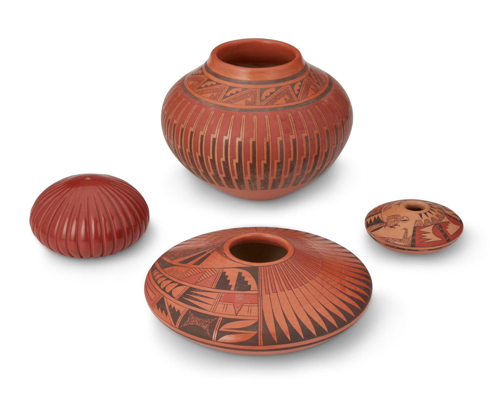 A group of Puebloan pottery vessels: A group of Puebloan pottery vessels Four works: Gloria Kahe (b. 1951, DinE) Three Navajo pottery vessels, late 20th/early 21st century Each signed: G. Kahe Each red and black slip glazed vessel with a