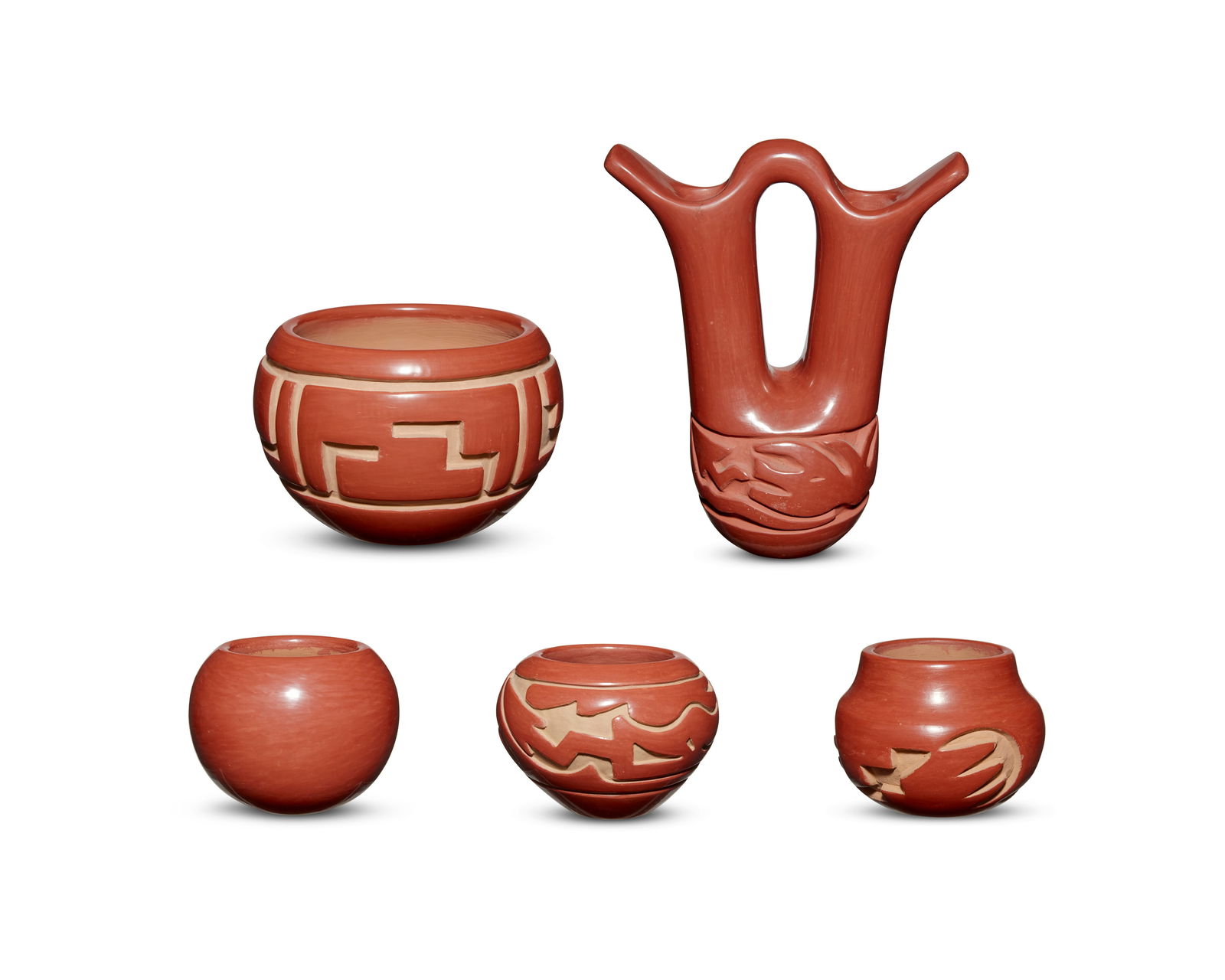 A group of Puebloan redware pottery: A group of Puebloan redware potteryFive works:Frances & Flora Naranjo (1936-2002 & 1914-2000, Santa Clara Pueblo)A Santa Clara redware bowl, mid/late 20th centurySigned to baseA small carved bowl with