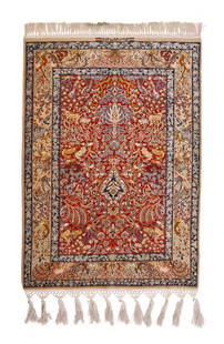 A Persian Isfahan rug: A Persian Isfahan rug Mid/late 20th century; Iran Signed: Mr. Sanaie The wool and silk on silk foundation rug with a polychrome Tree of Life motif on a scarlet ground 5' 5" H x 3' 6" W 