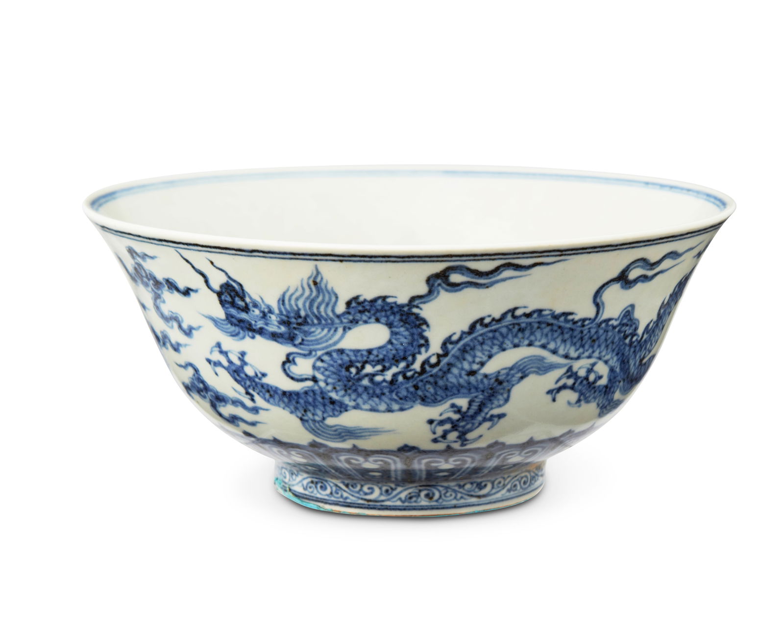 A Chinese blue and white porcelain dragon bowl: A Chinese blue and white porcelain dragon bowl20th centuryMarked to the underside in blue underglaze bearing an apocryphal reign mark for Xuande Period (1426-1435)Decorated in blue underglaze with dra