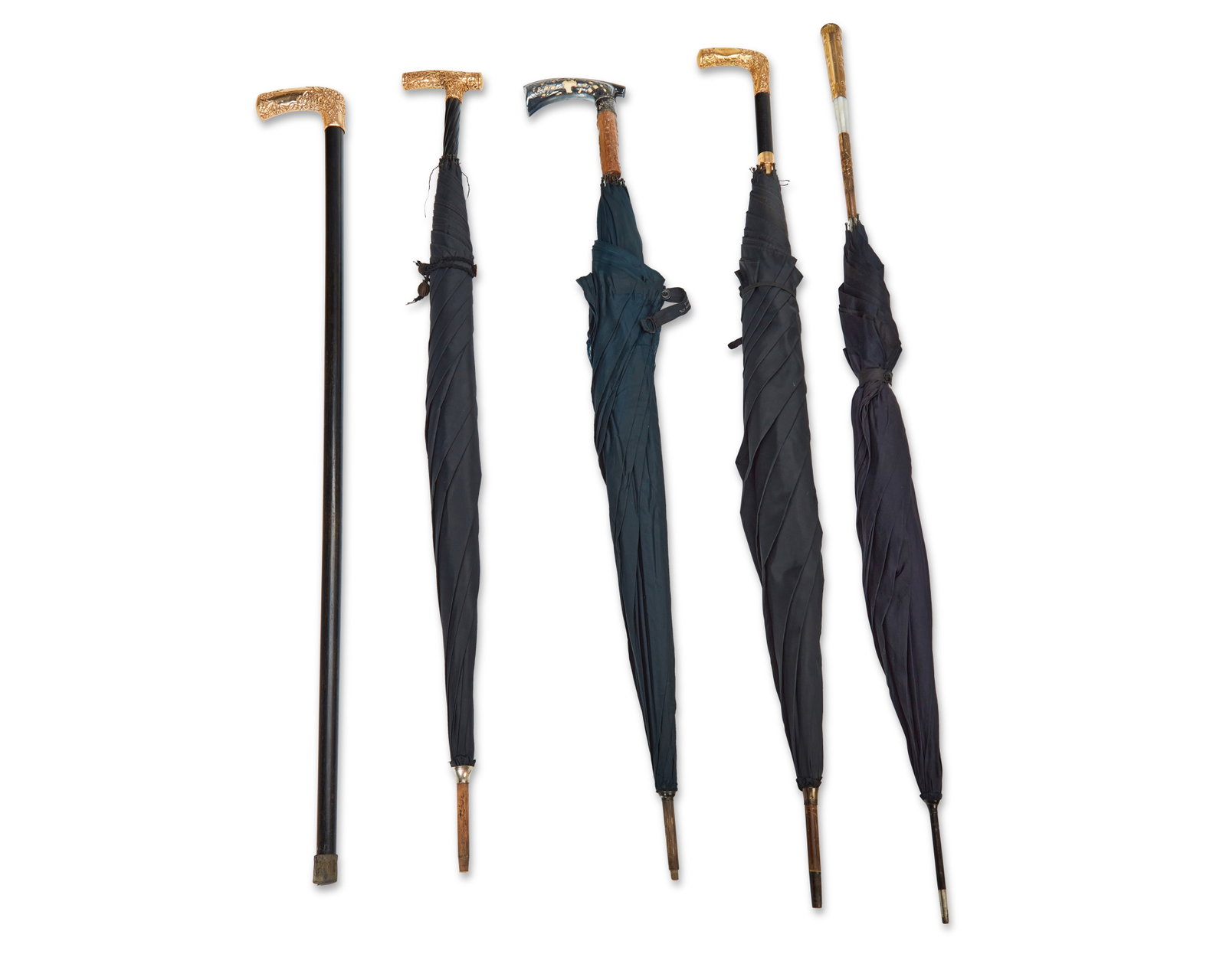A group of umbrellas and a cane: A group of umbrellas and a cane 20th century Each unmarked Comprising one cane with gold-toned metal handle, two ebonized wood umbrellas with gold-toned metal handles, one wood umbrella with gold-tone