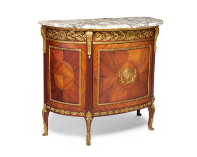 A transitional Louis XV/XVI-style marquetry demilune commode: A transitional Louis XV/XVI-style marquetry demilune commode20th centuryThe wood cabinet featuring marquetry veneer and mounted gilt-bronze trim and accents in egg-and-dart and scrolled laurel wreath