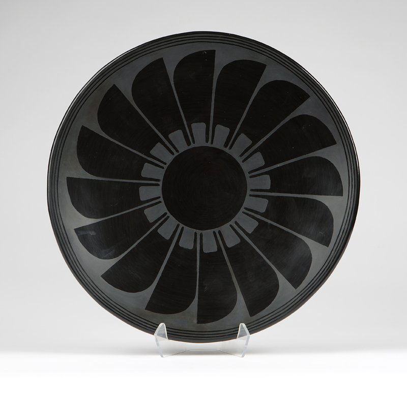 A San Ildefonso blackware plate, Maria & Julian: 20th century, signed ''Marie & Julian'' (Maria & Julian Martinez), of shallow flaring form, painted in matte against a highly polished slip with a design of three concentric narrow bands encircling a