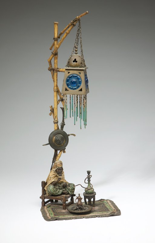 A Franz Bergman cold-painted bronze figural lamp: Late 19th / early 20th century, Austrian, with foundry mark to underside, also with retailer's label marked ''M. Klein / (?) Blvd des Italiens, Paris'', depicting an Arab man holding a cup seated on a