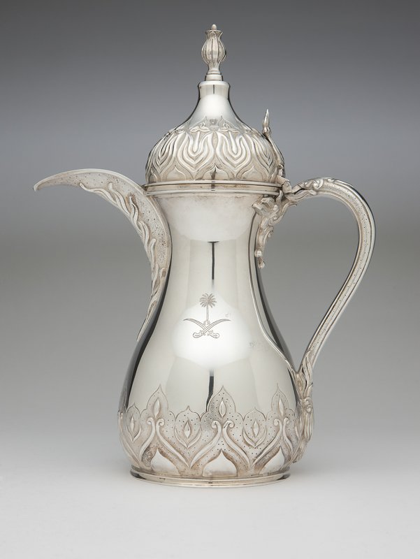 An English sterling silver coffee pot, Asprey: 1976, London, with maker's mark and further marked twice ''Asprey London'', the waisted circular body with hinged, domed cover decorated in Arabian manner and with the national emblem of Saudi Arabia,
