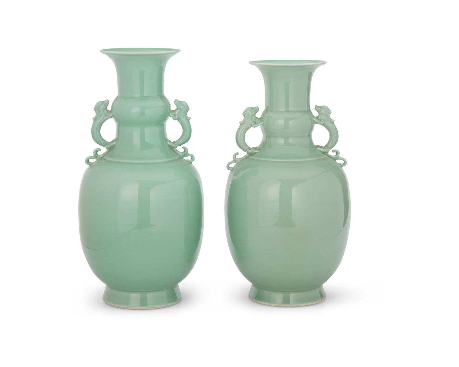 A pair of Chinese celadon porcelain vases: A pair of Chinese celadon porcelain vases20th centuryMarked to the underside in blue underglaze bearing an apocryphal reign mark for Qianlong Period (1711-1799)Each with opposed dragon handles applied