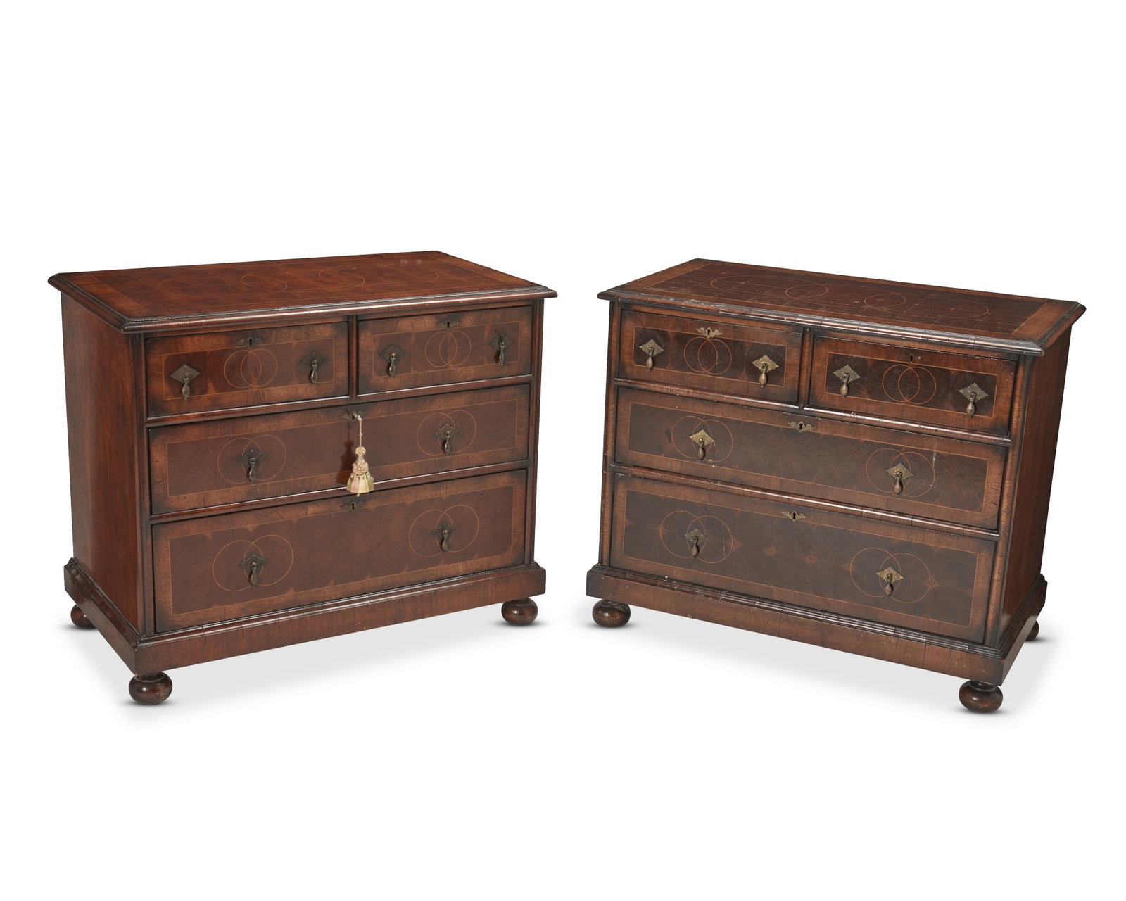 A pair of English William & Mary-style chest of drawers: A pair of English William & Mary-style chest of drawers Early 20th century Two conformingly designed mahogany veneered chests, each with two half-width drawers set above two full-width drawers below, 