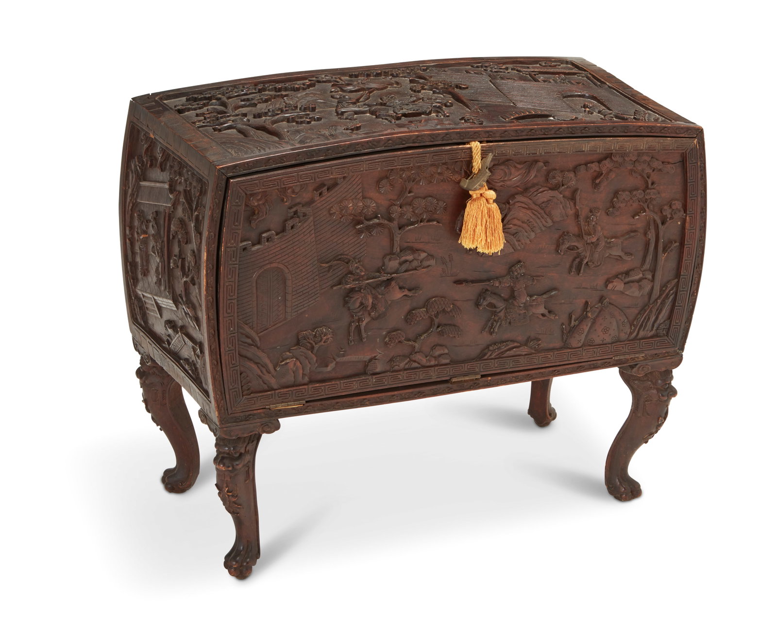 A Chinese carved wood chest: A Chinese carved wood chest 20th century With haute-relief carving depicting a battle scene and a single drop-front door revealing a fitted interior with two shelves and raised on figural dragon legs 