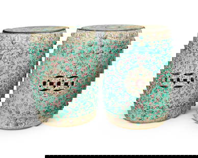 A pair of Chinese Famille Verte-style porcelain garden stools: A pair of Chinese Famille Verte-style porcelain garden stools20th centuryEach appears unmarkedThe glazed ceramic stools with all-over floral and foliate motifs on pale green ground centering a floral
