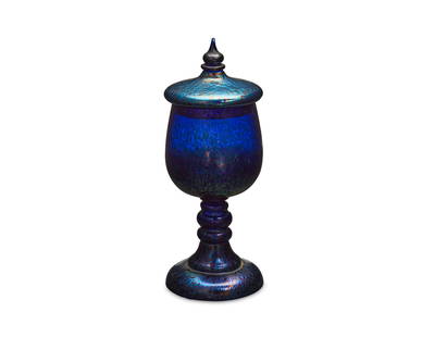 A Bohemian iridescent art glass compote: A Bohemian iridescent art glass compoteLate 20th centuryMarked: CzechoslovakiaThe lidded oil spot blue glass compote with spire finial10.75" H x 4" Dia. Provenance: Estate of Domingo Amestoy