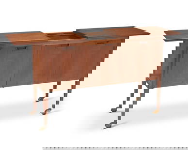 A John Stuart Inc. bar cart: A John Stuart Inc. bar cart(1948-1956)With applied metal plaquette: John Stuart Inc / New York / Grand Rapids; burn marked to drawer interior: Janus collectionDesigned by John Stuart for the "Jan