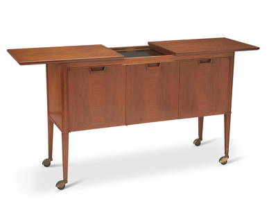 A John Stuart Inc. bar cart: A John Stuart Inc. bar cart(1948-1956)With applied metal plaquette: John Stuart Inc / New York / Grand Rapids; burn marked to drawer interior: Janus collectionDesigned by John Stuart for the "Jan