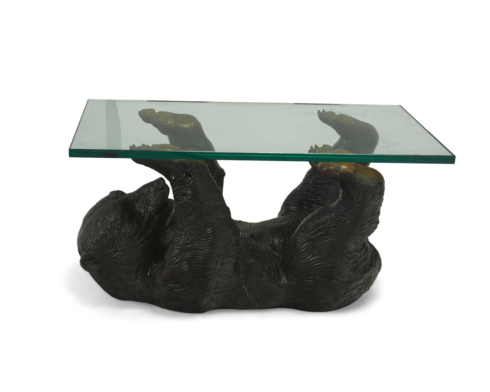 A brass sculptural bear table: A brass sculptural bear tableMid/late 20th centuryAppears unmarkedThe painted hollow brass table in the figure of a recumbent black bear with its legs supporting the glass topBear: 16.5" H x 30&q
