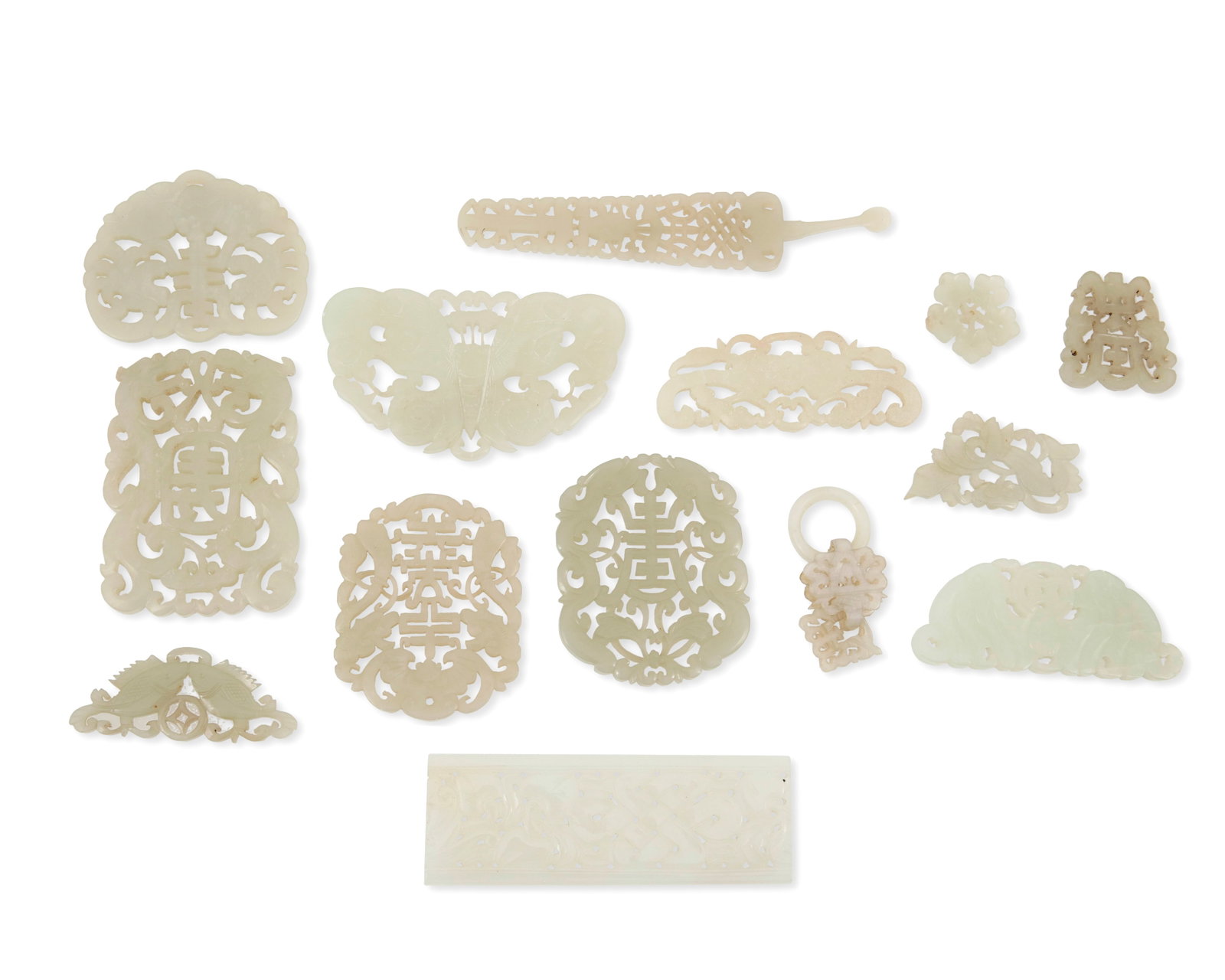 A large group of reticulated jade and hardstone ornaments: A large group of reticulated jade and hardstone ornaments Qing dynasty and/or later Fourteen works comprising intricately reticulated pendants and carvings in various shapes and sizes, with bats, shou