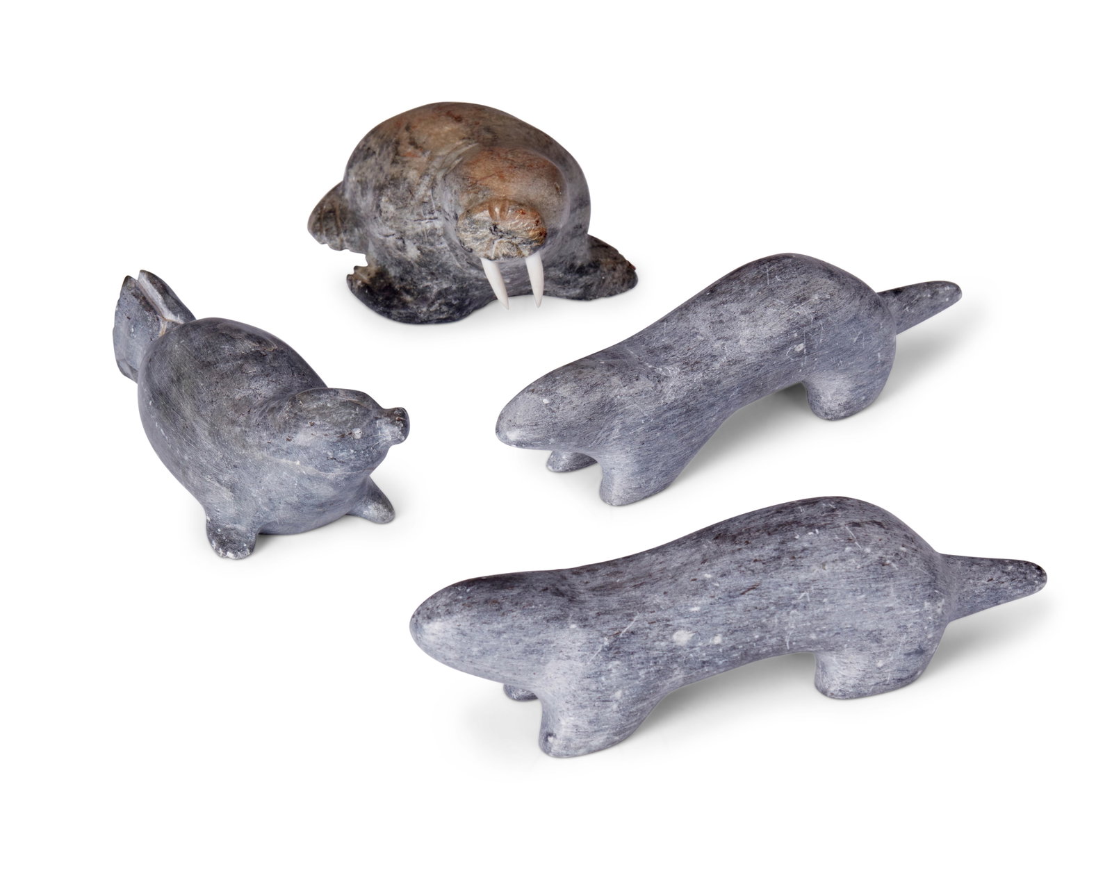 Four Inuit carved stone animals: Four Inuit carved stone animals Four works: John Ayek (1938-1999, Inuit) A carved stone walrus figure with bone tusks, mid-20th century Signed to underside: J Ayek 1.875" H x 2.875" W x 4.62