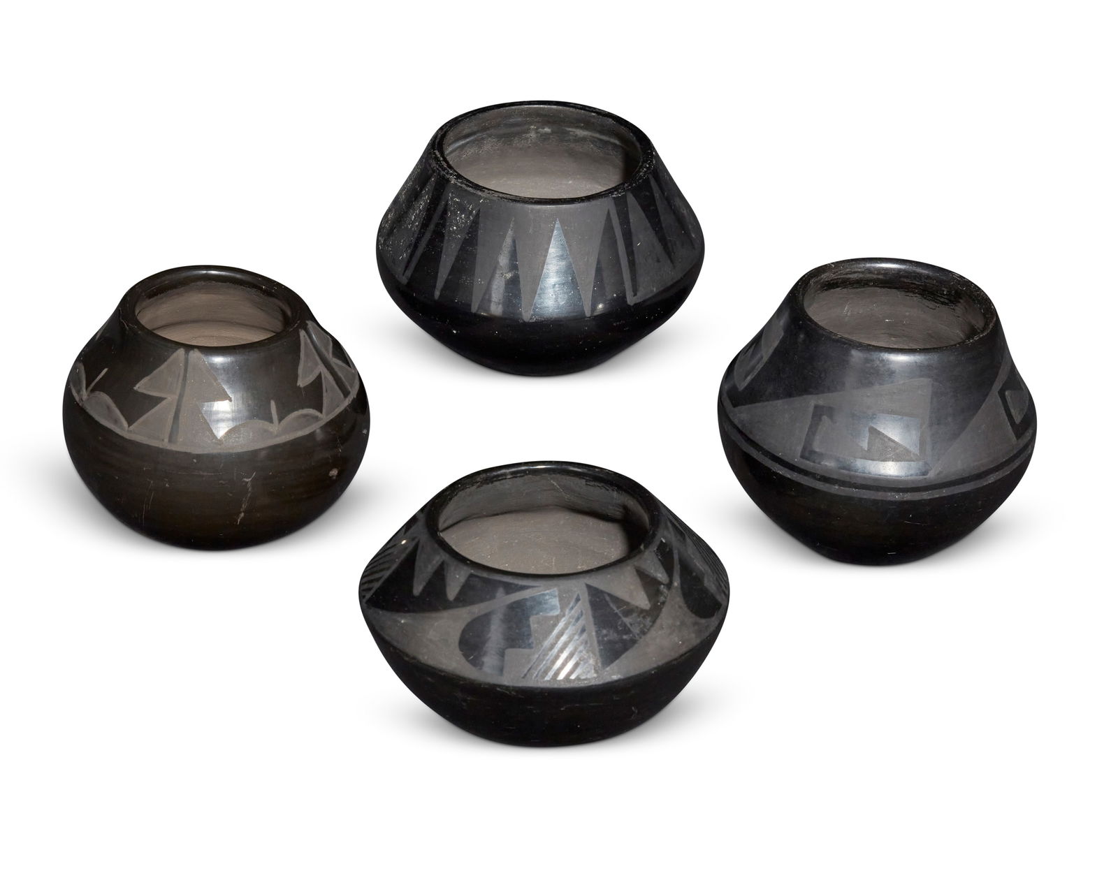 Four Puebloan blackware pottery bowls: Four Puebloan blackware pottery bowlsFour works:Desideria Montoya (1889-1982, San Ildefonso Pueblo)A blackware bowl, mid-20th centurySigned to underside: DesideriaThe small bowl with painted slip geom